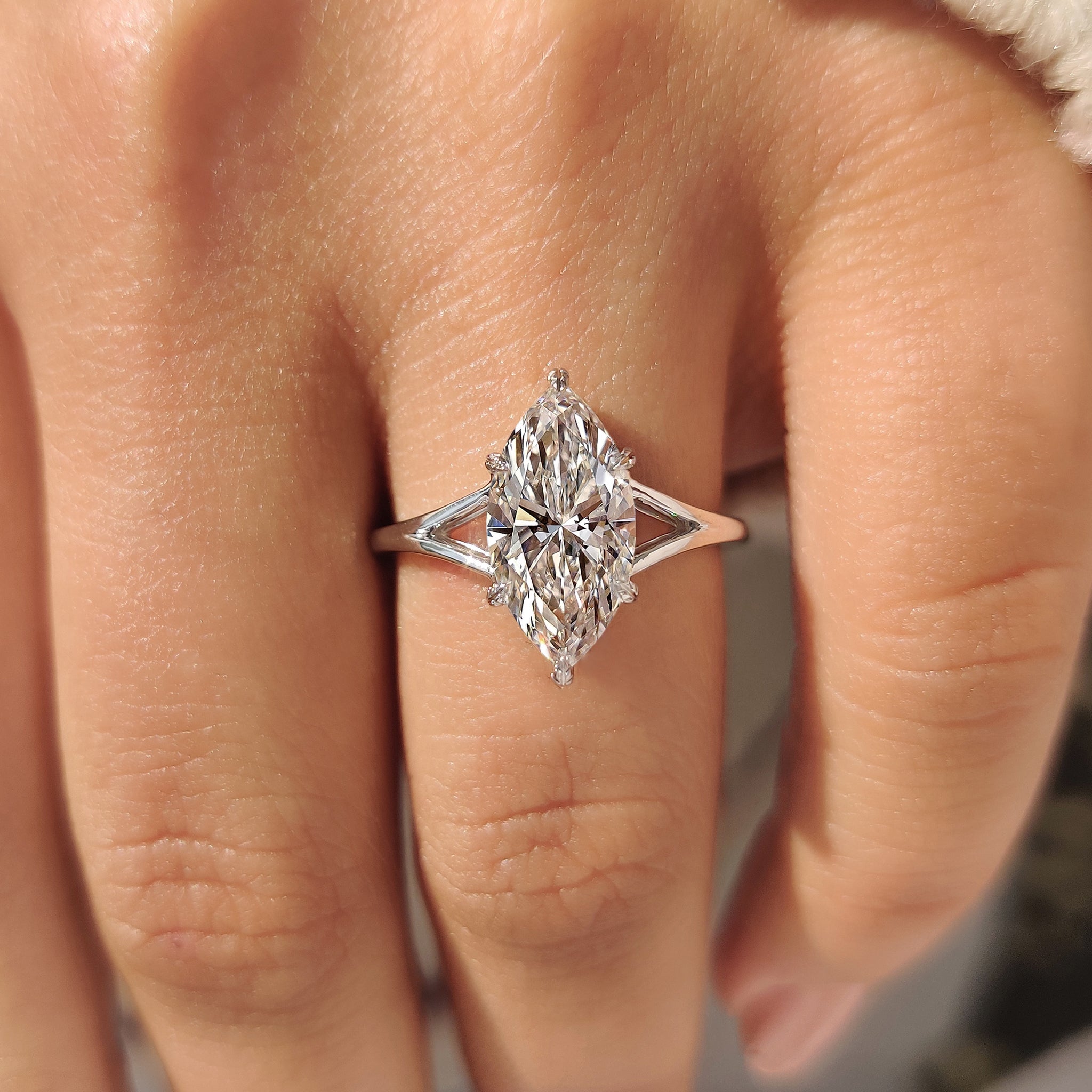 Lab grown marquise diamond ring with six leaf prong.
