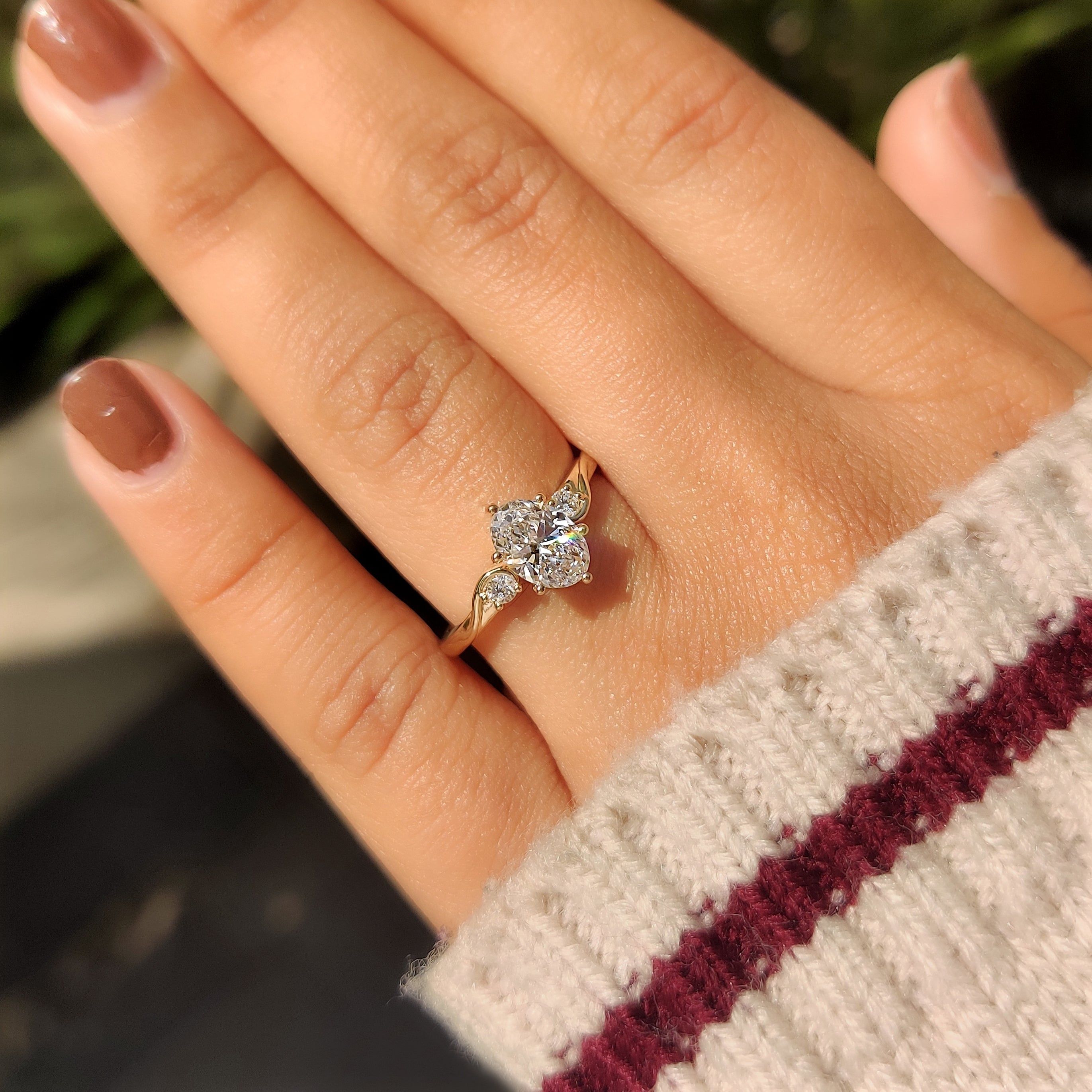 Round side stone oval diamond ring with prong setting
