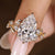 Pear shaped diamond ring with nature inspired and round side stones
