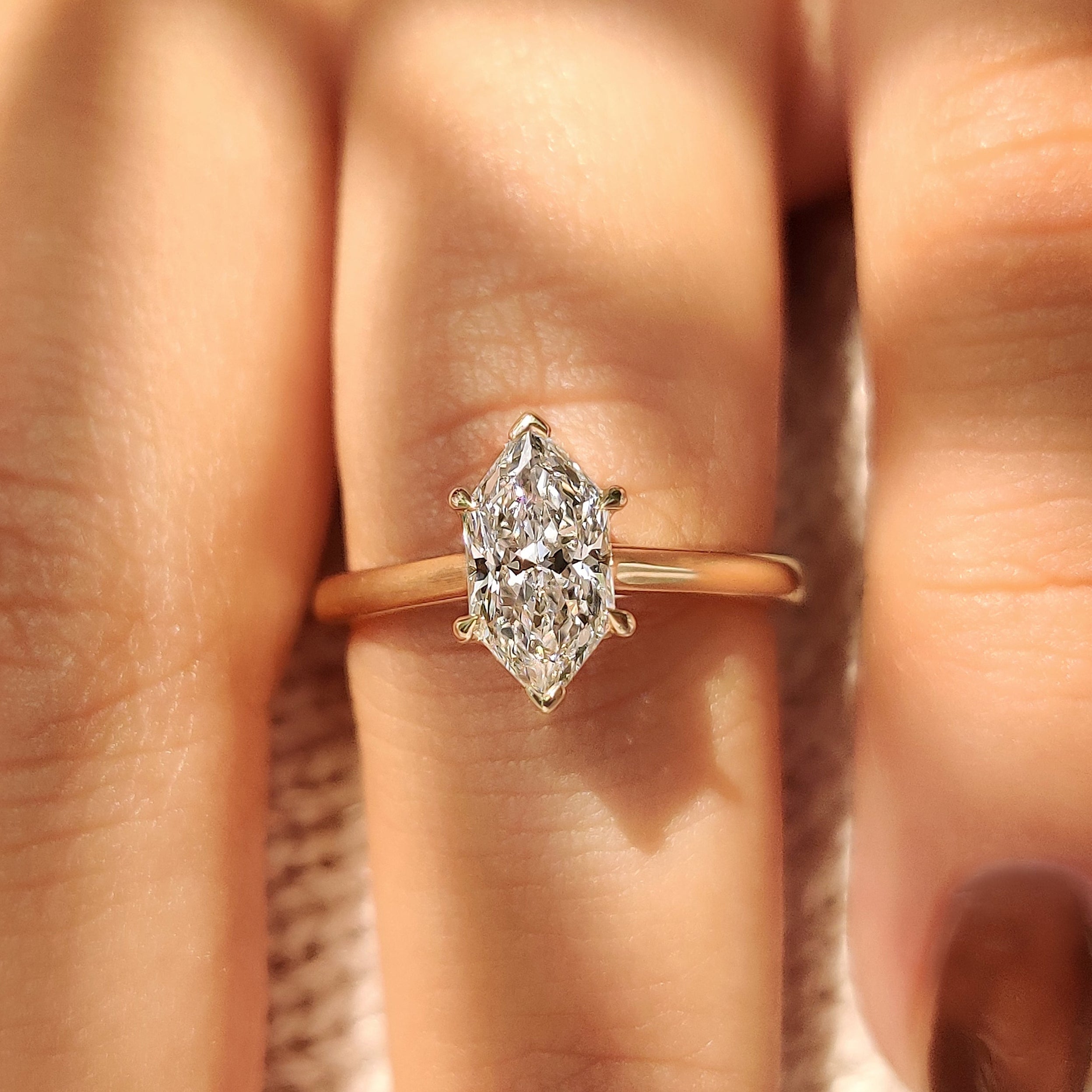 Dutch marquise diamond ring with round diamond bridge accent
