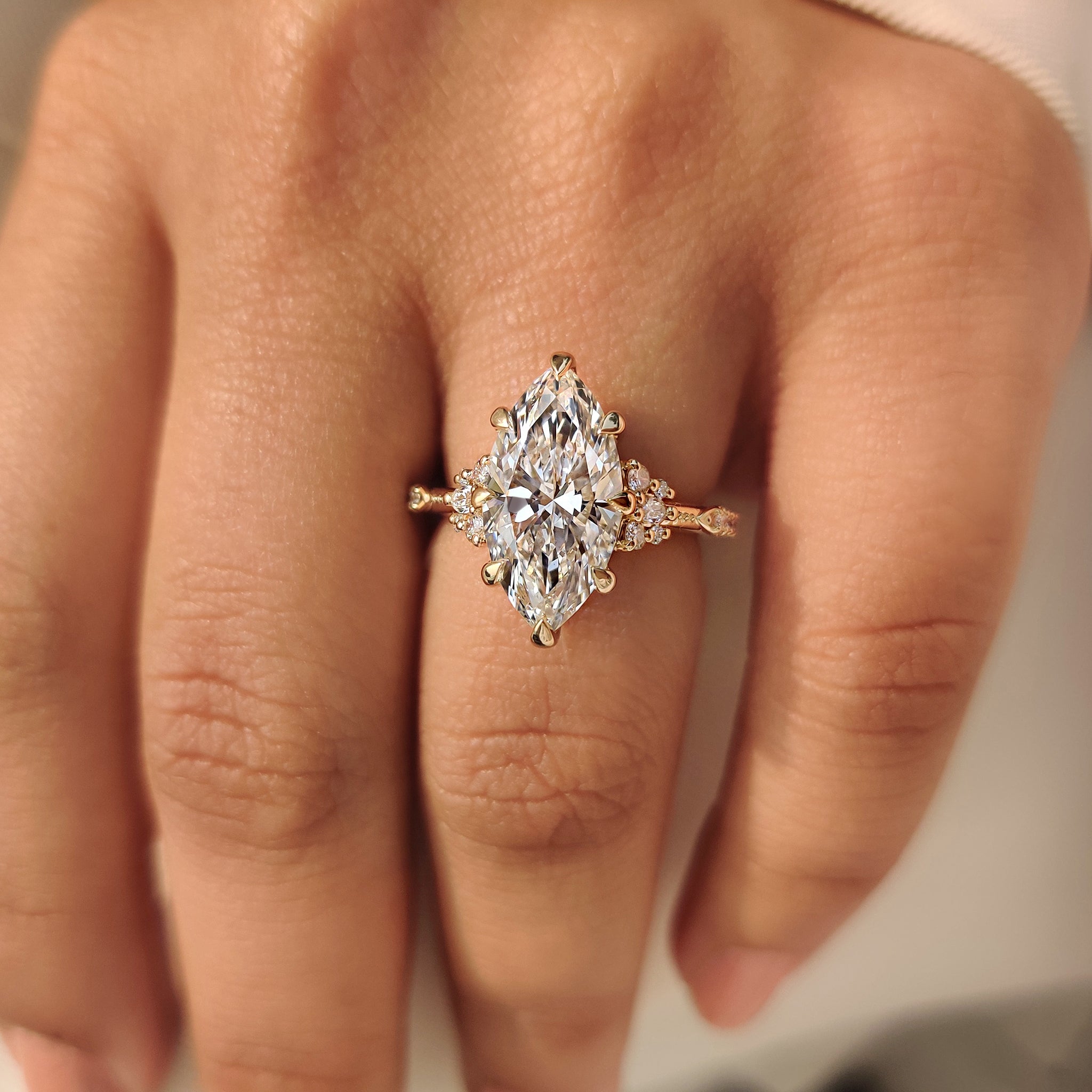 Vintage marquise engagement ring with round side accents
