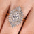 Oval diamond ring with double halo and baguette accents
