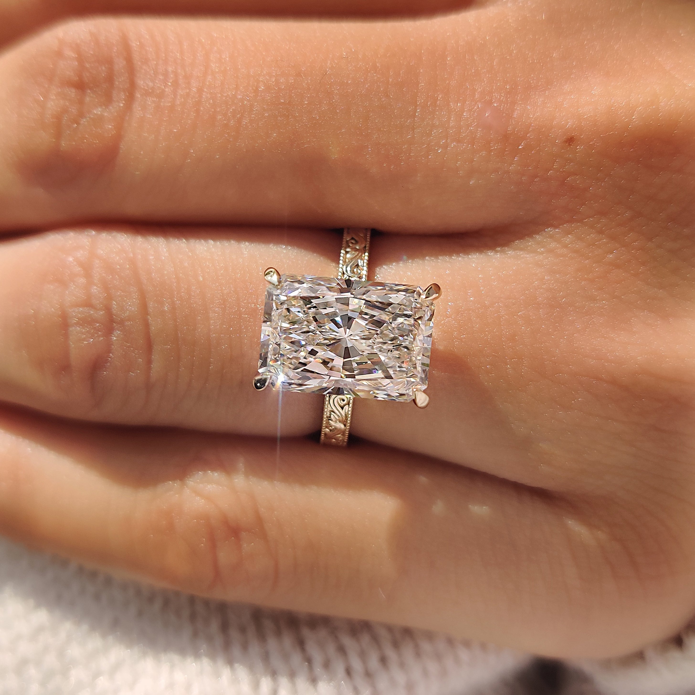 Radiant engagement ring with milgrain details.
