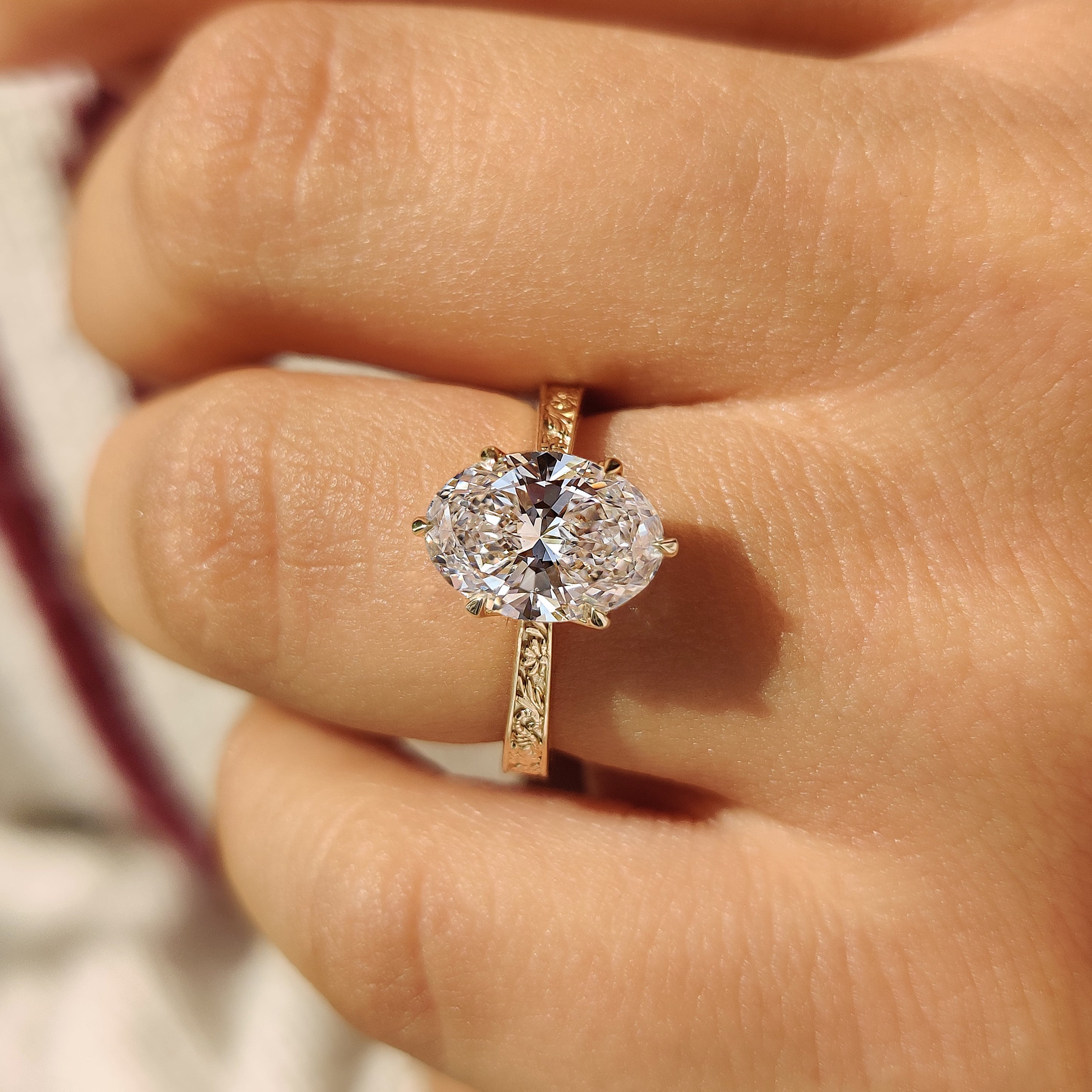 Handmade oval diamond ring with vintage inspired engraving details
