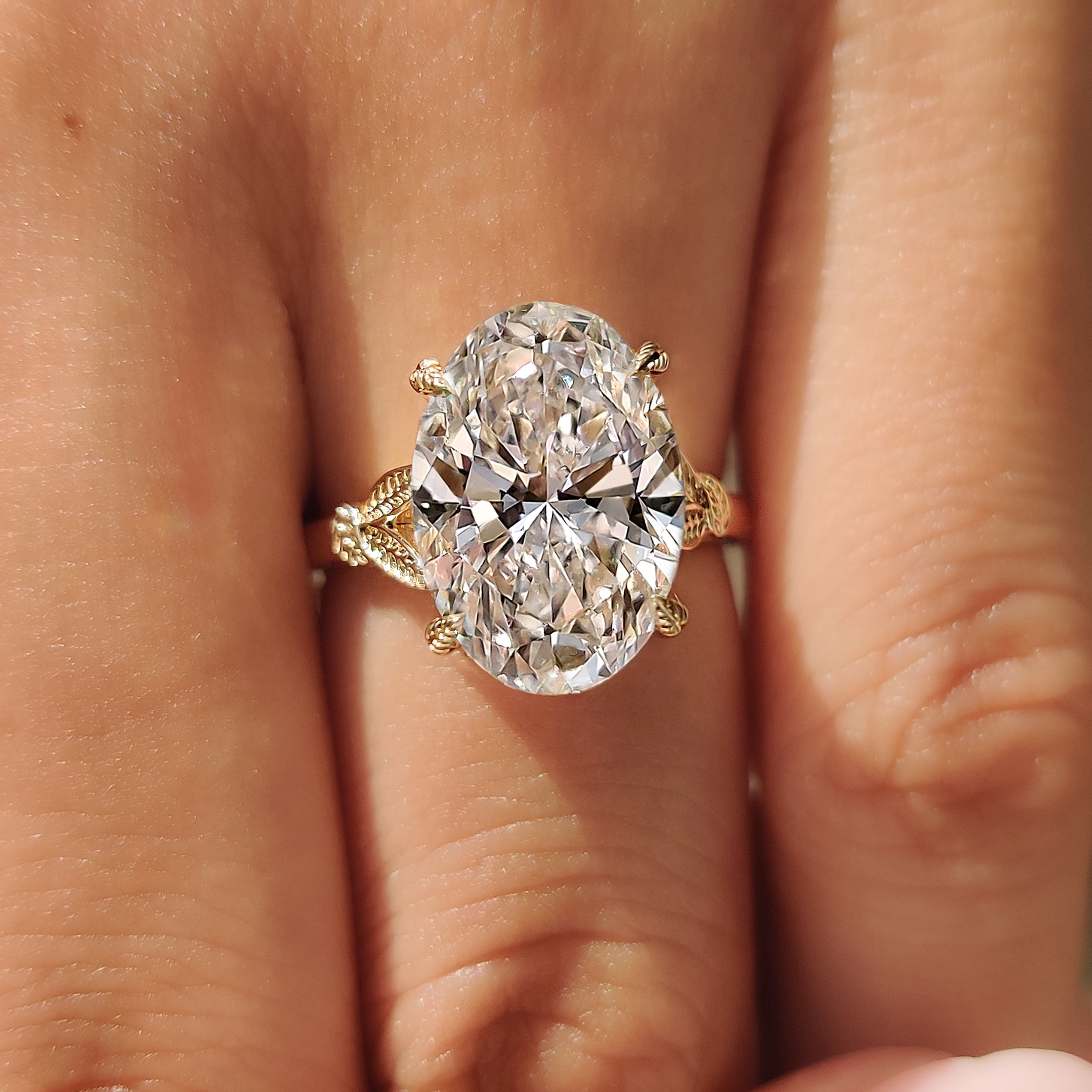Four leaf style prong oval diamond ring
