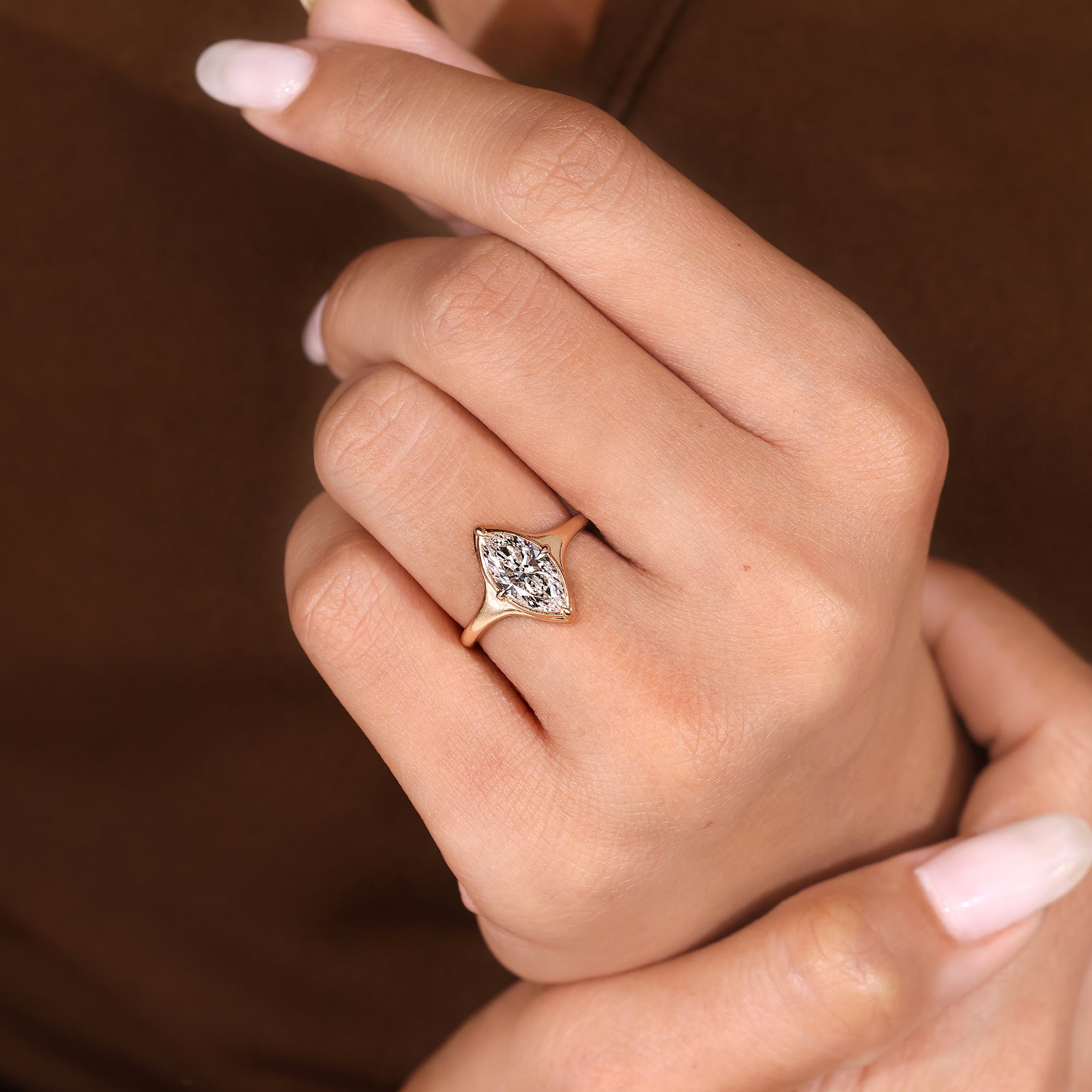Solitaire bezel setting marquise cut diamond ring by Carat Diamonds.