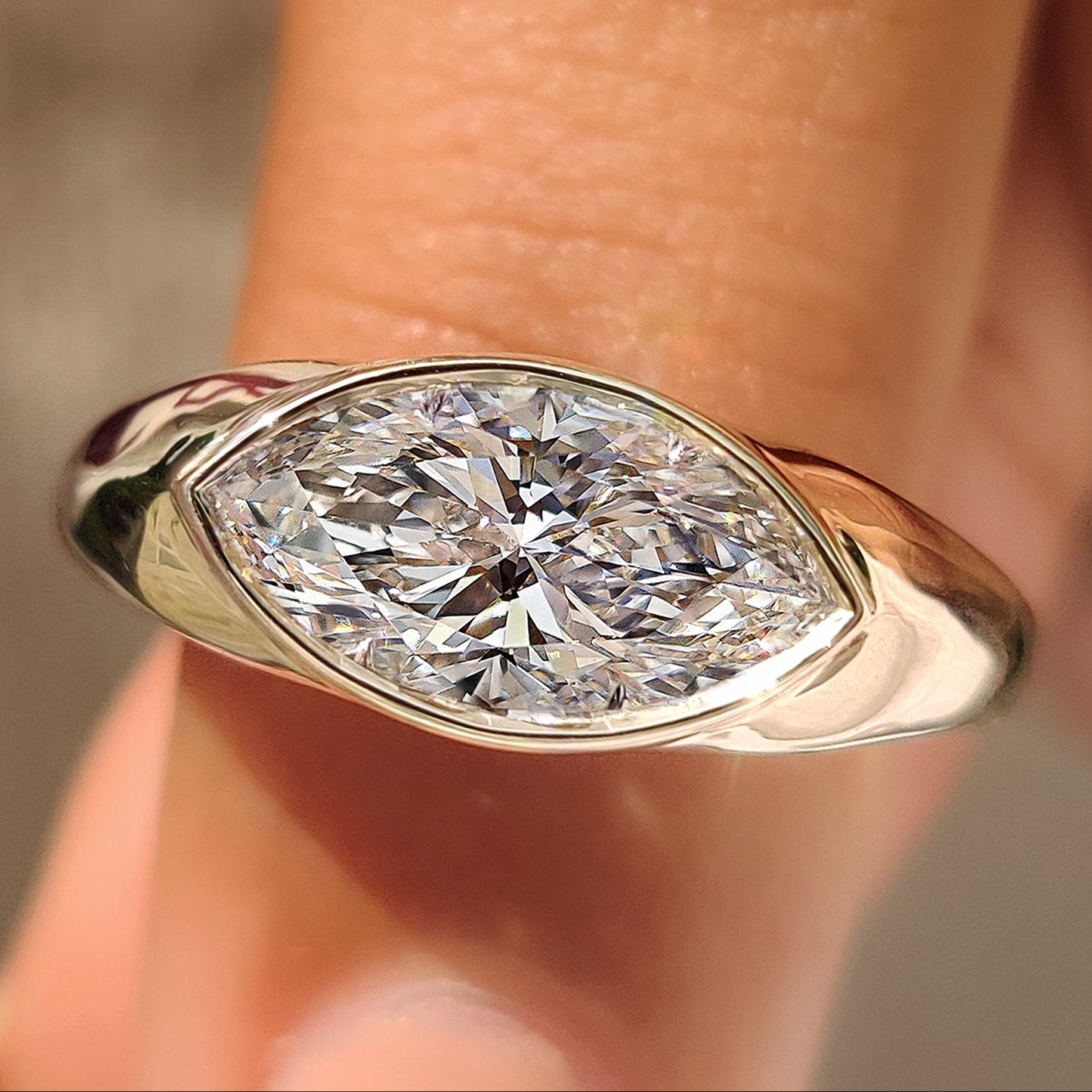 Marquise engagement ring with full bezel setting
