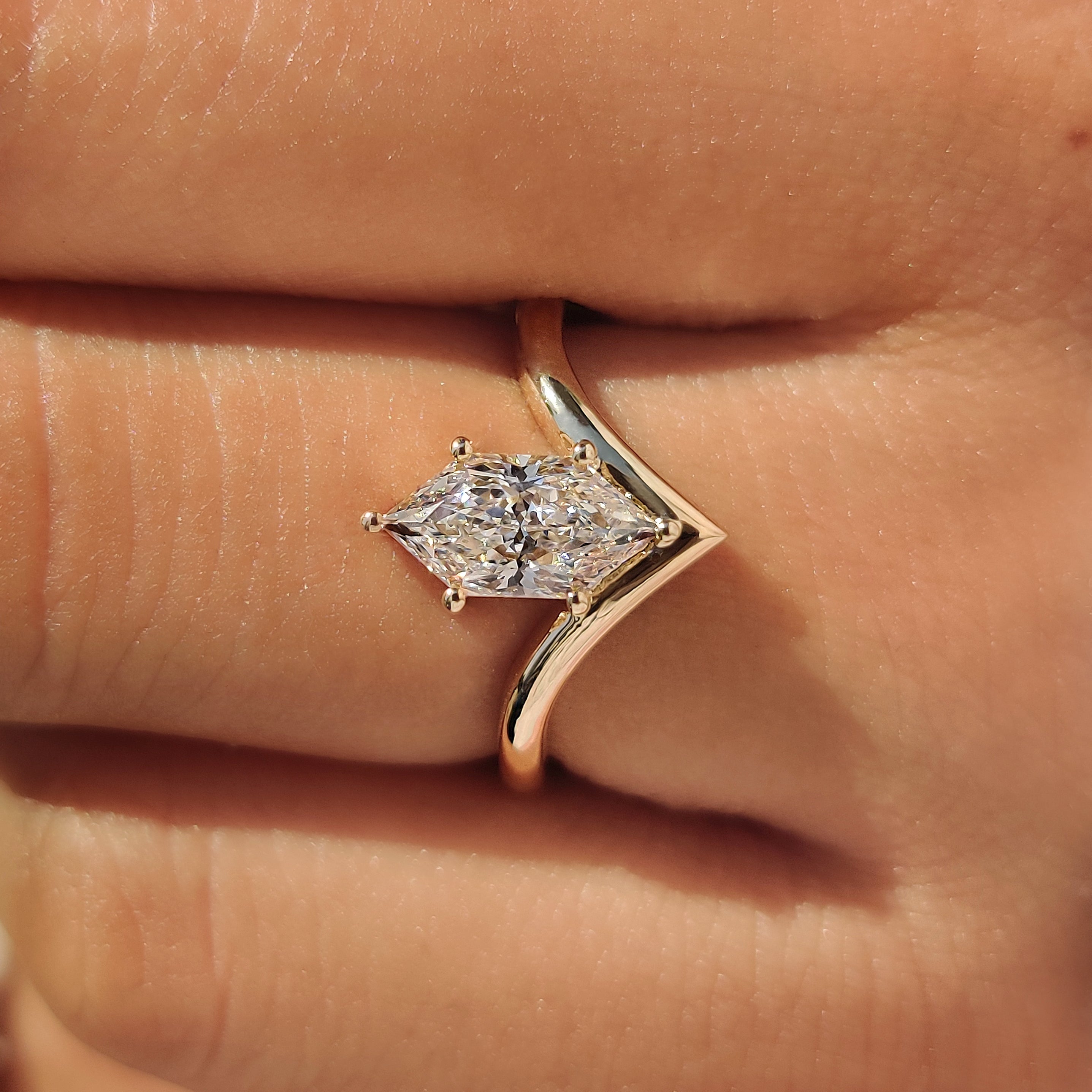 Yellow gold engagement ring with a Dutch marquise cut diamond.
