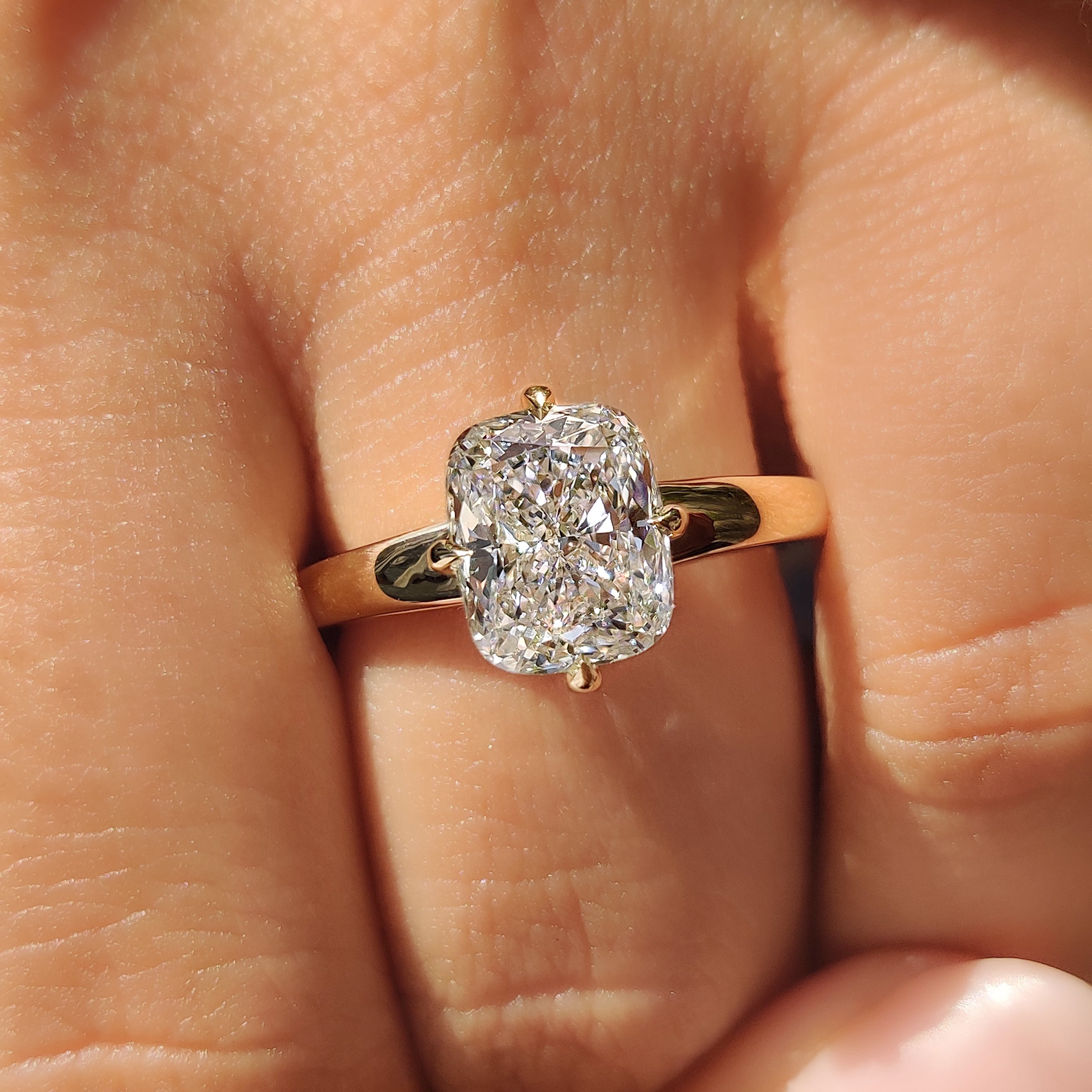 Handmade cushion cut diamond ring with compass prongs
