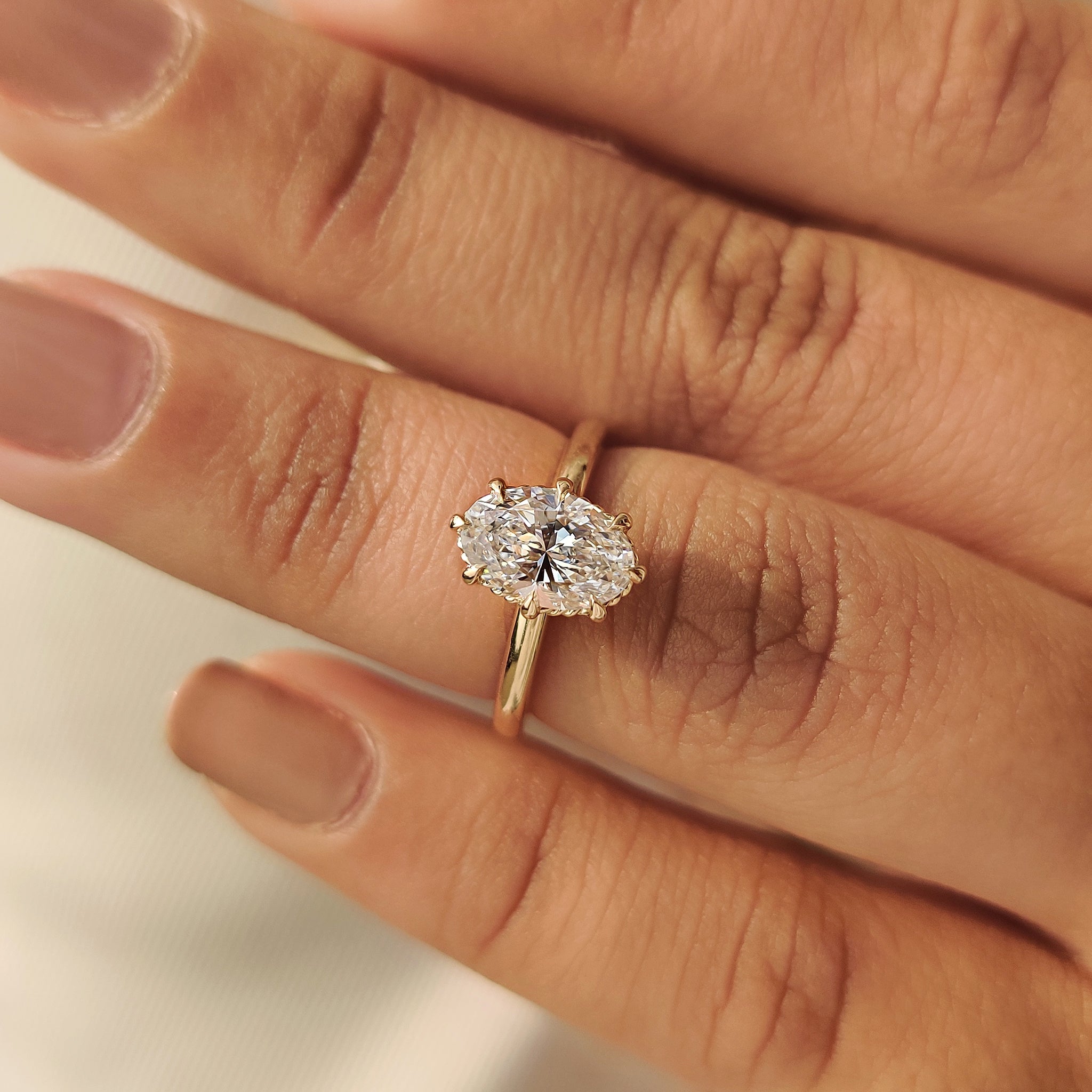 Solitaire oval engagement ring with eight claw prong setting by Carat Diamonds
