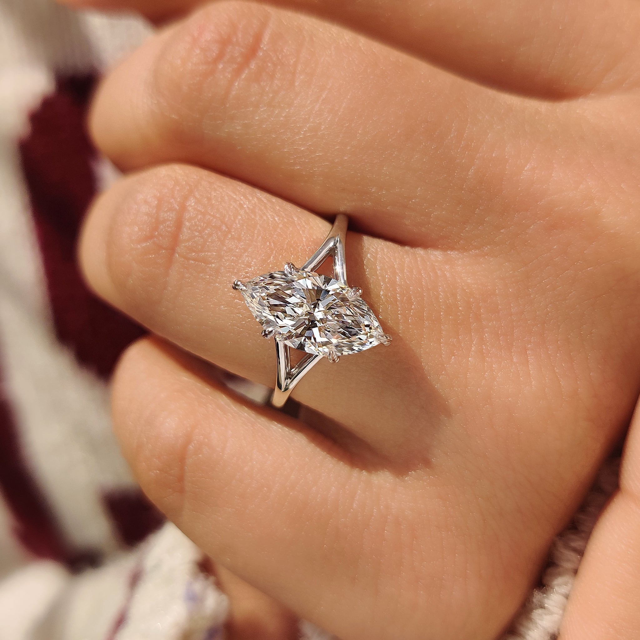 Lab grown marquise solitaire diamond ring with split shank.

