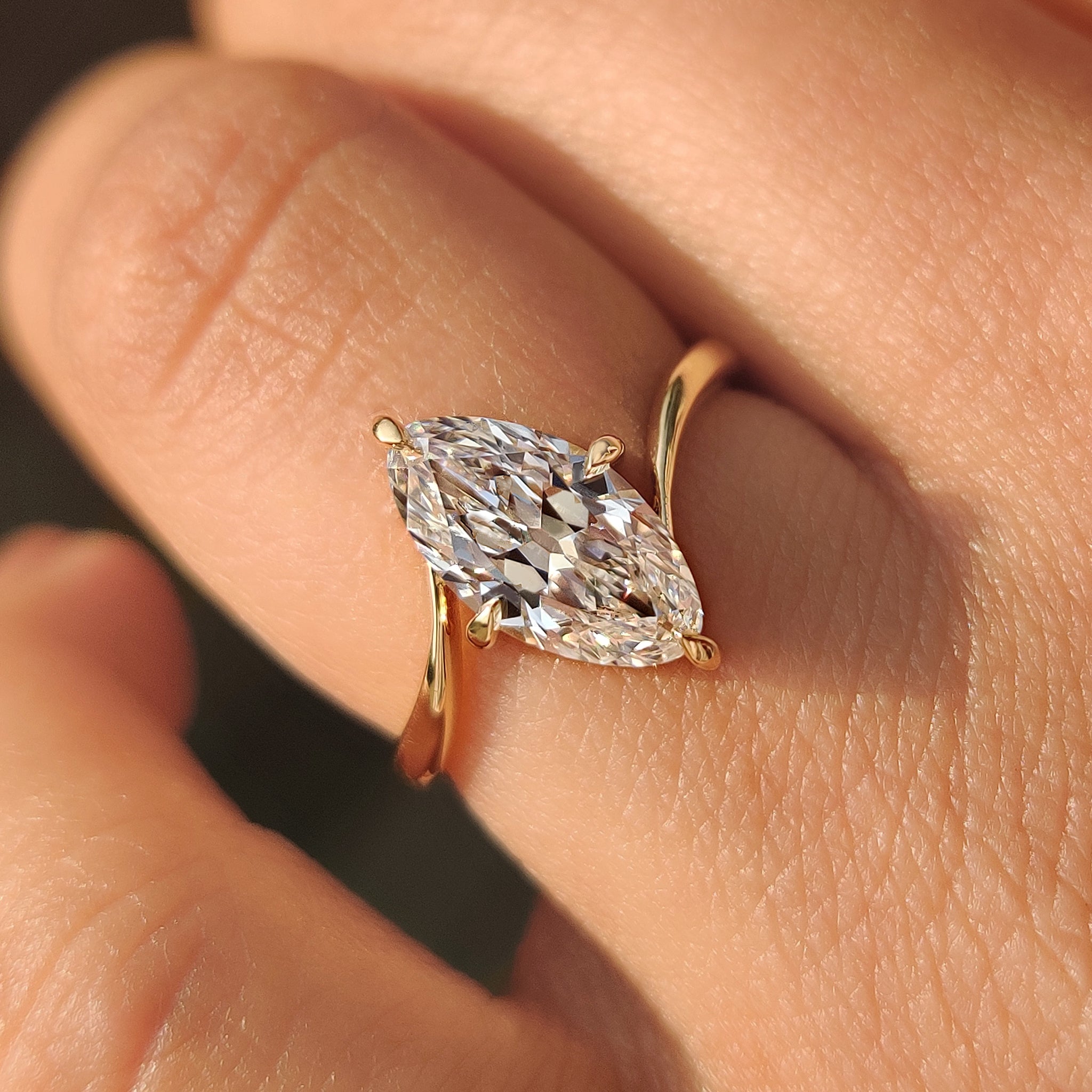 Marquise diamond ring featuring compass prong setting
