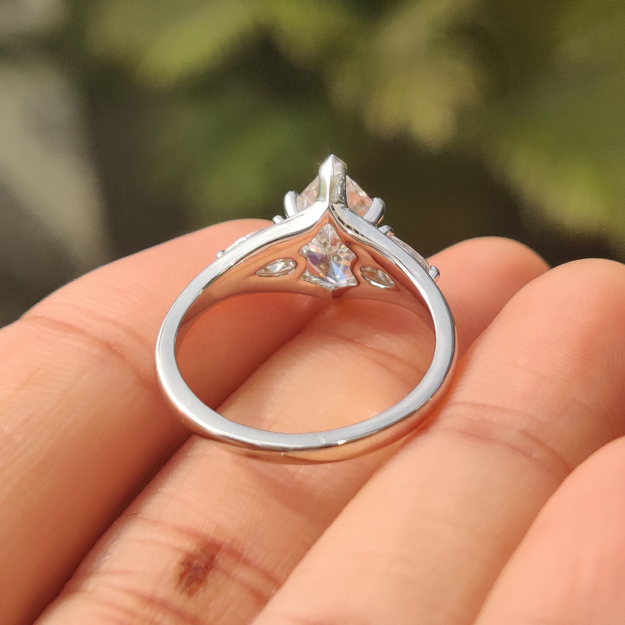 Marquise diamond ring with pear accents and V prongs.

