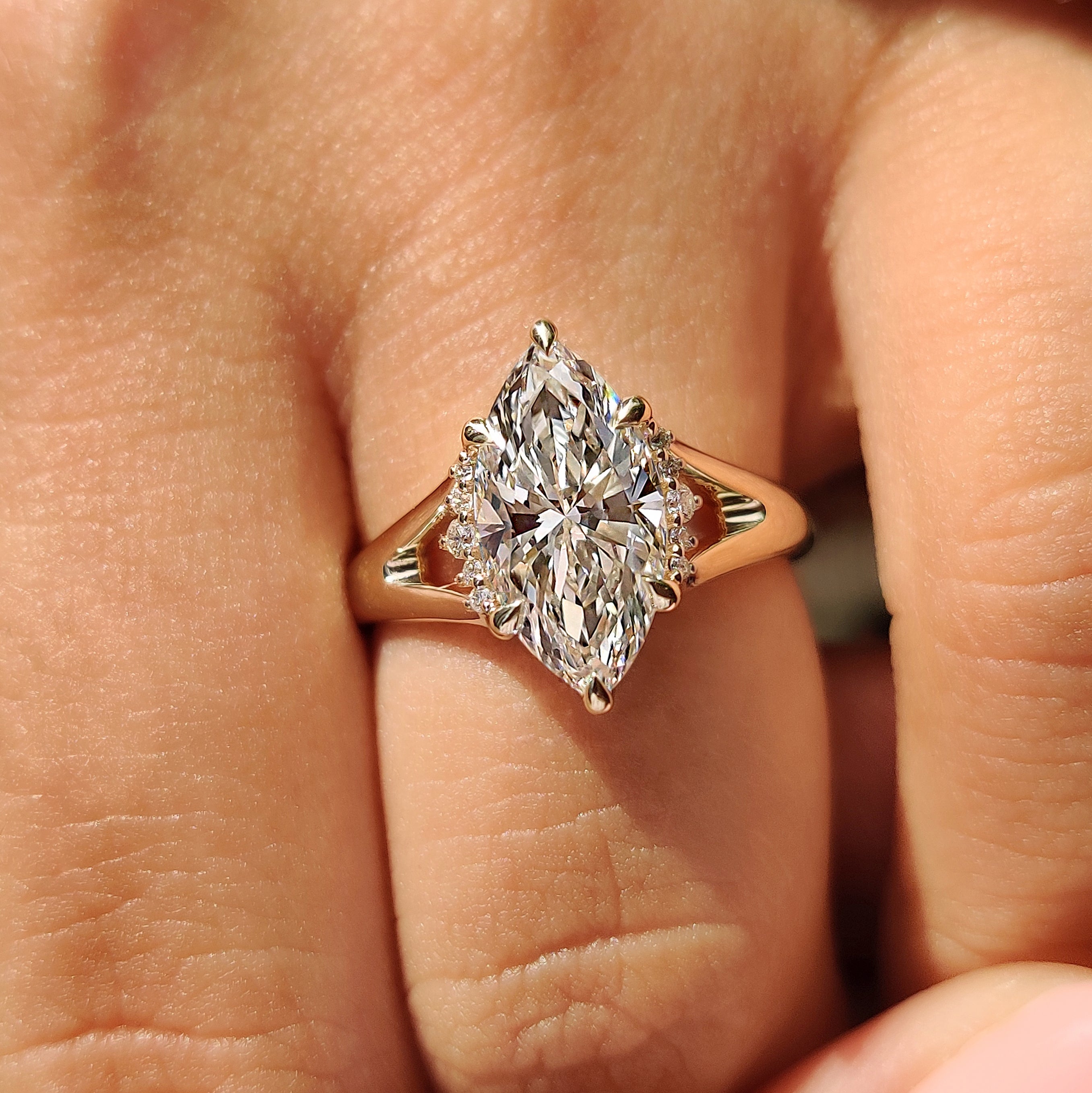 Marquise engagement ring with six claw prongs and ruby
