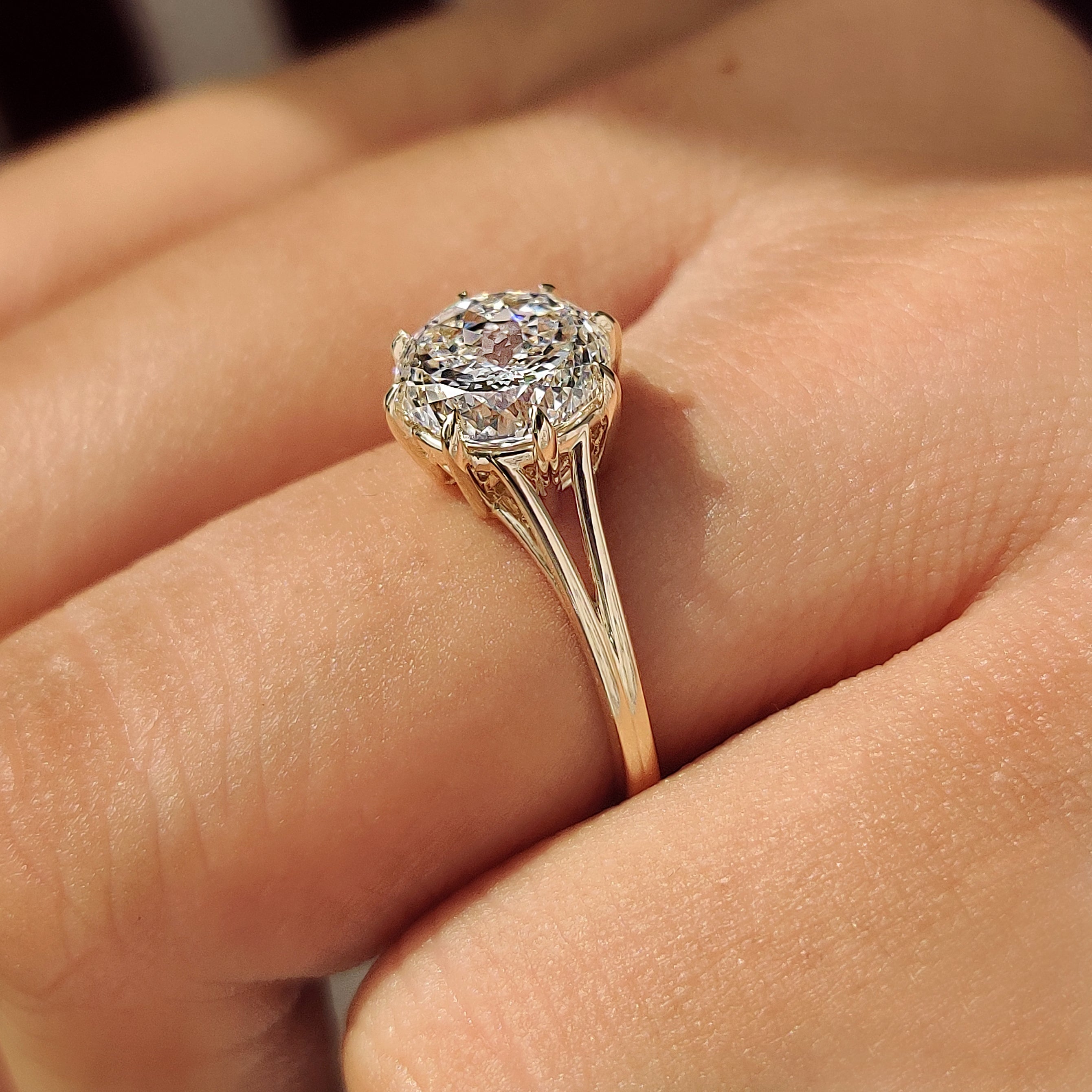 Split shank solitaire engagement ring with Portuguese cut.