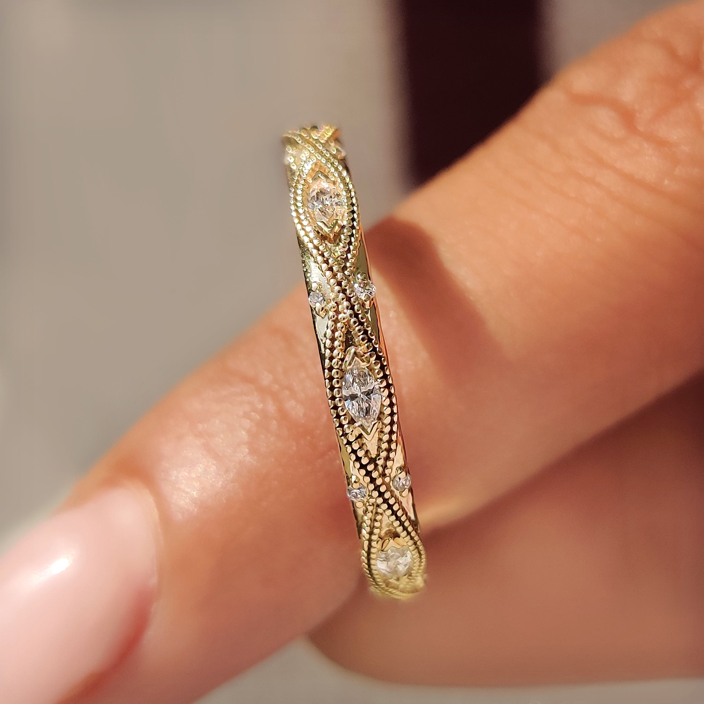 Stackable wedding band with marquise and round diamonds.
