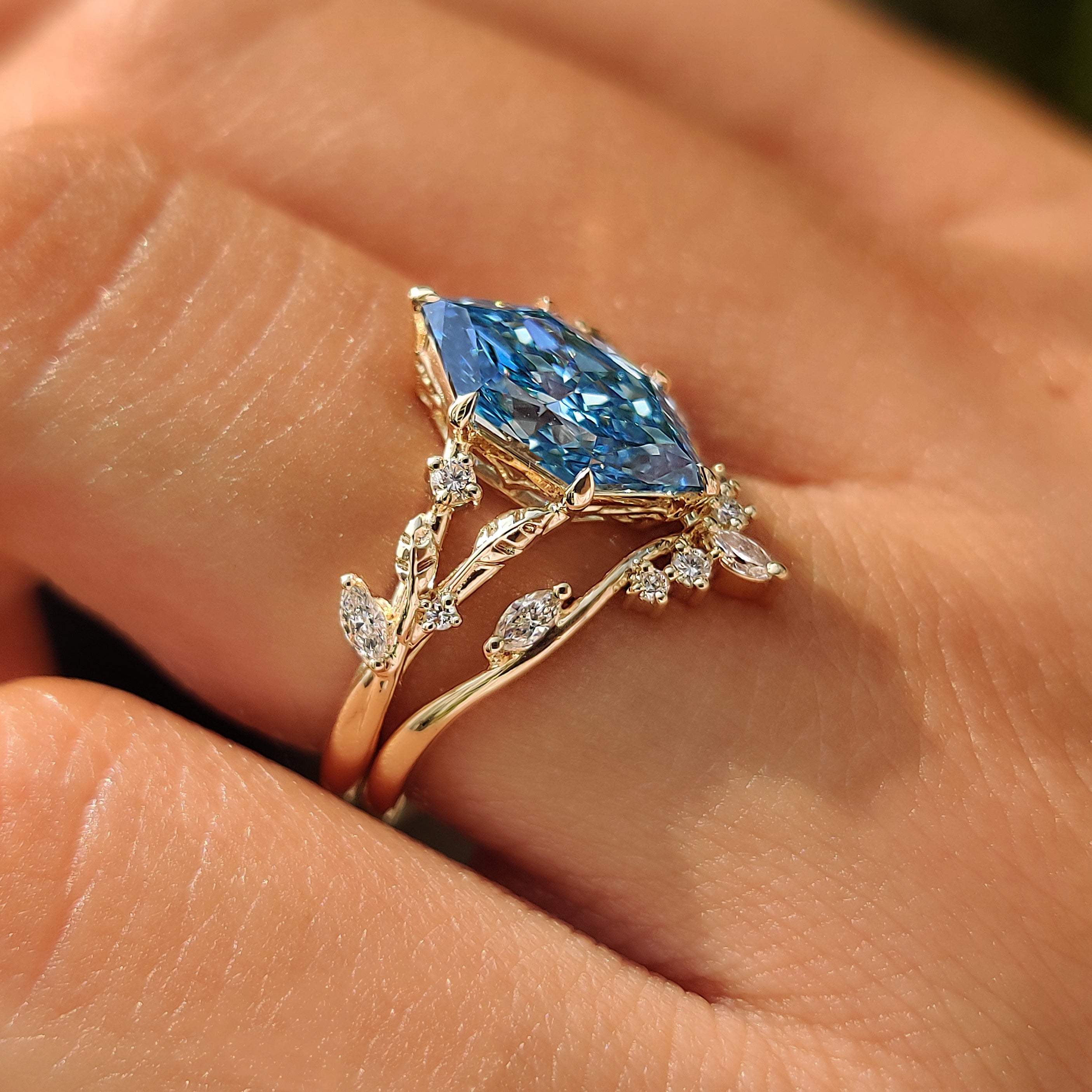 Blue Dutch marquise center diamond in a bridal ring set.
