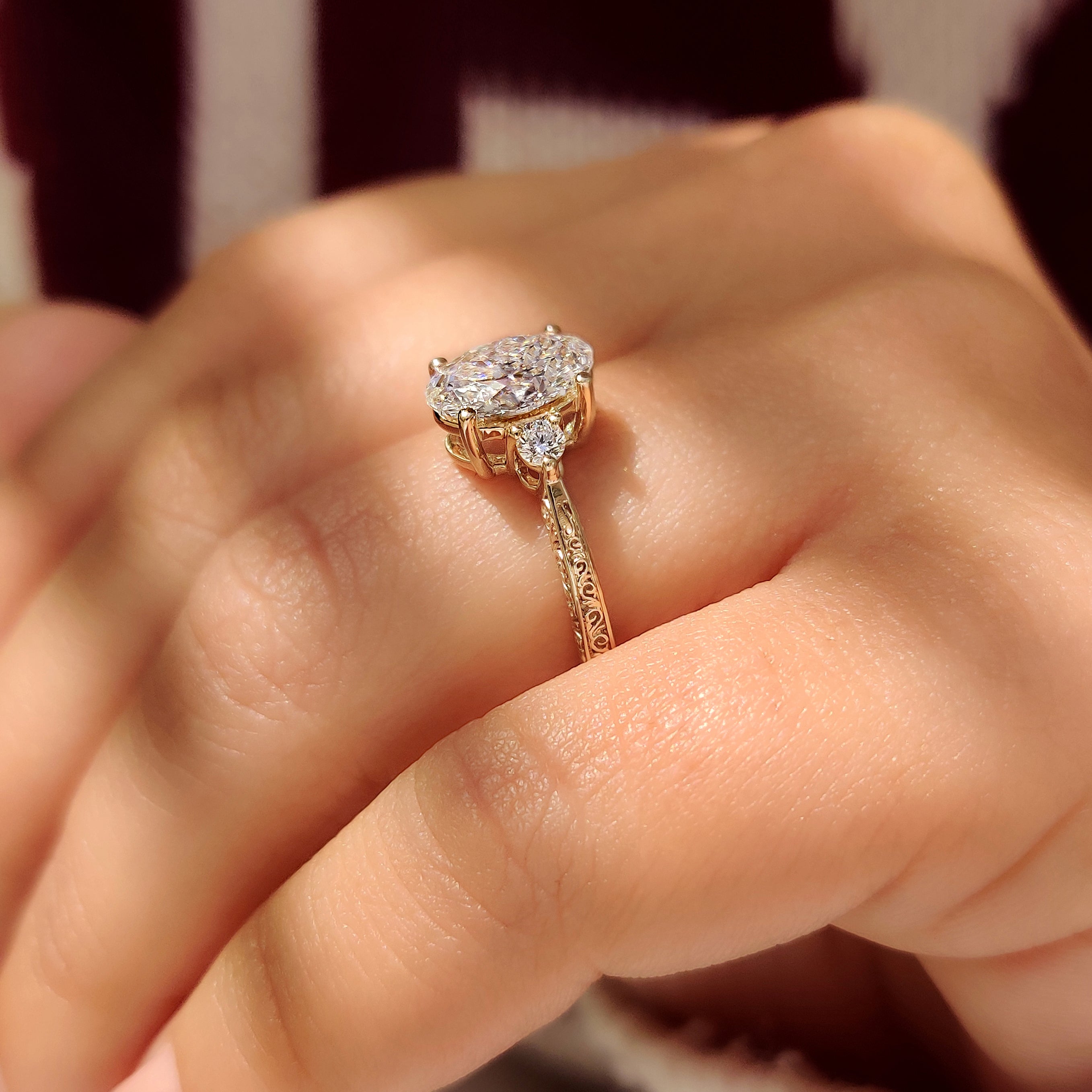 Oval lab grown diamond ring with hand engraved shank.
