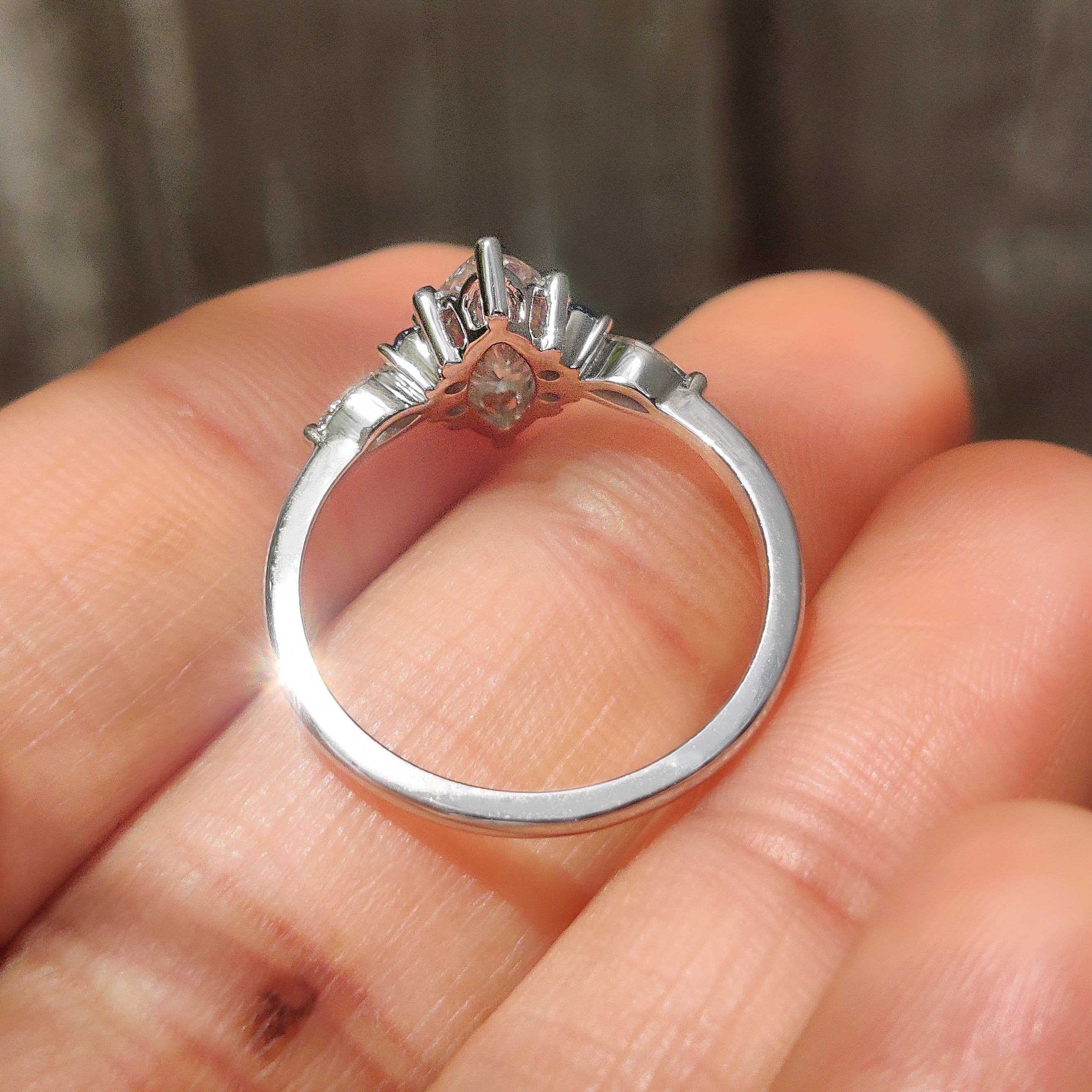 Seven stone marquise diamond ring with blue sapphire accents
