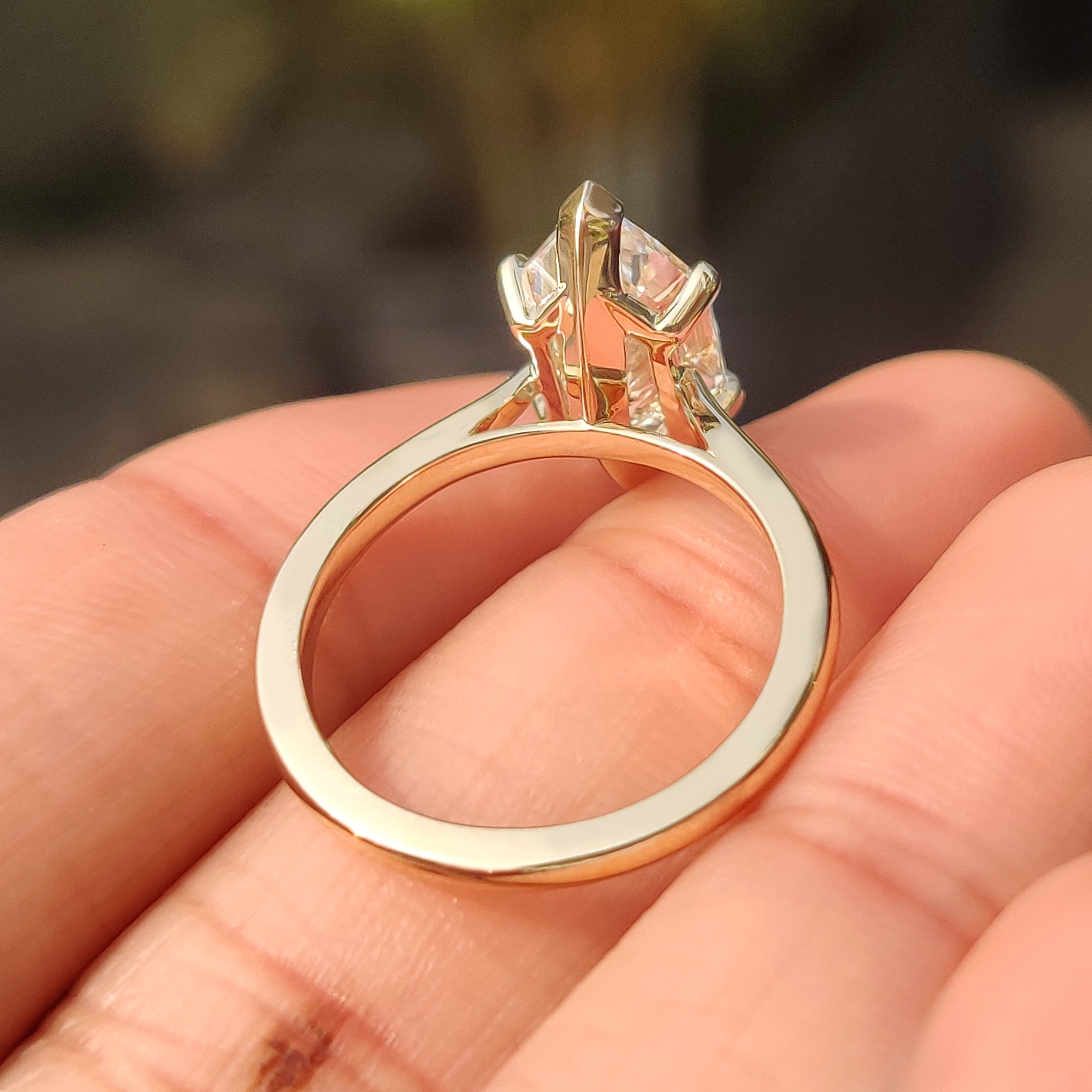 Dutch marquise lab diamond ring with four claw prongs.
