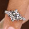 Three diamond ring with hexagon center and baguette sides.
