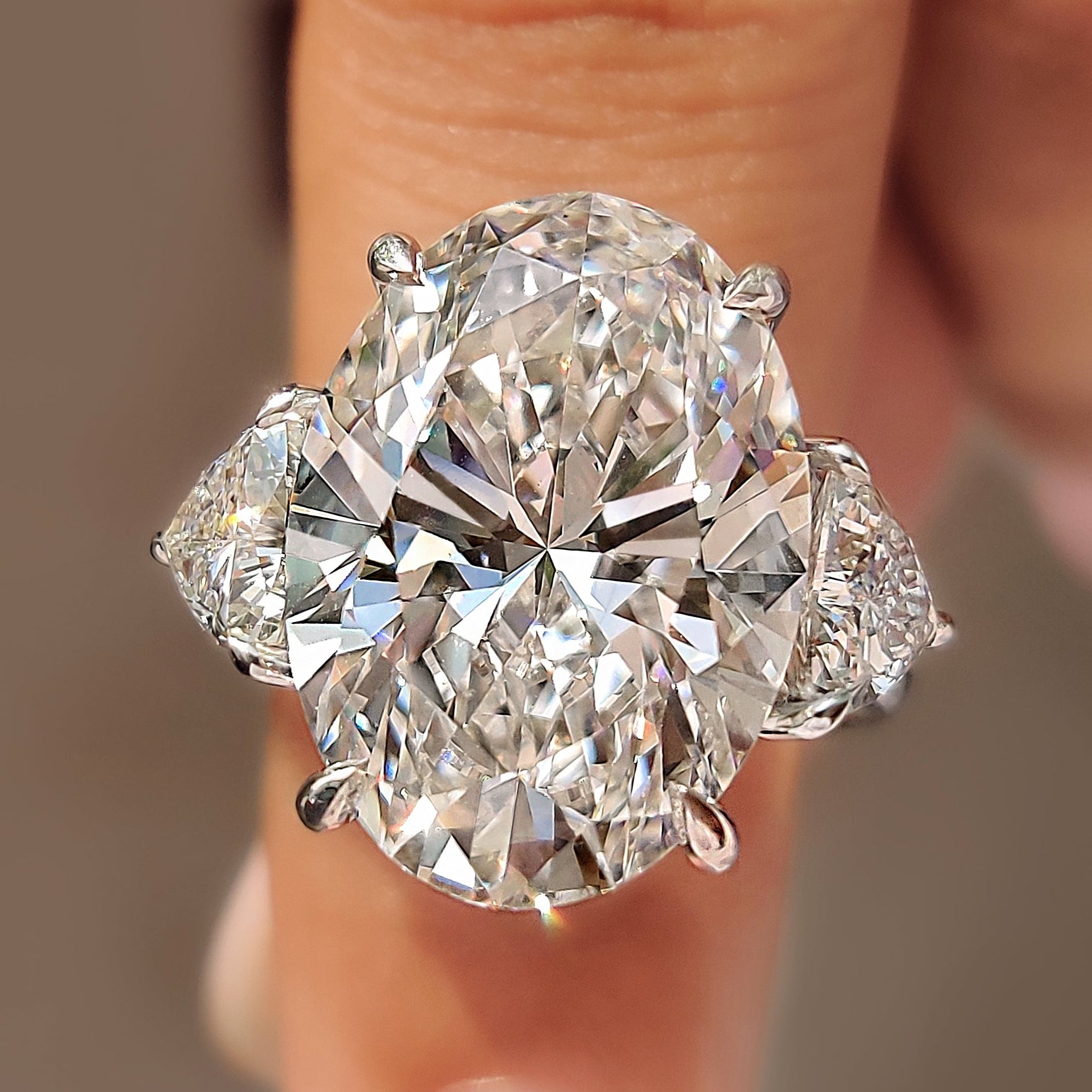 Oval diamond ring with trillion side stones
