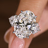 Oval diamond ring with trillion side stones
