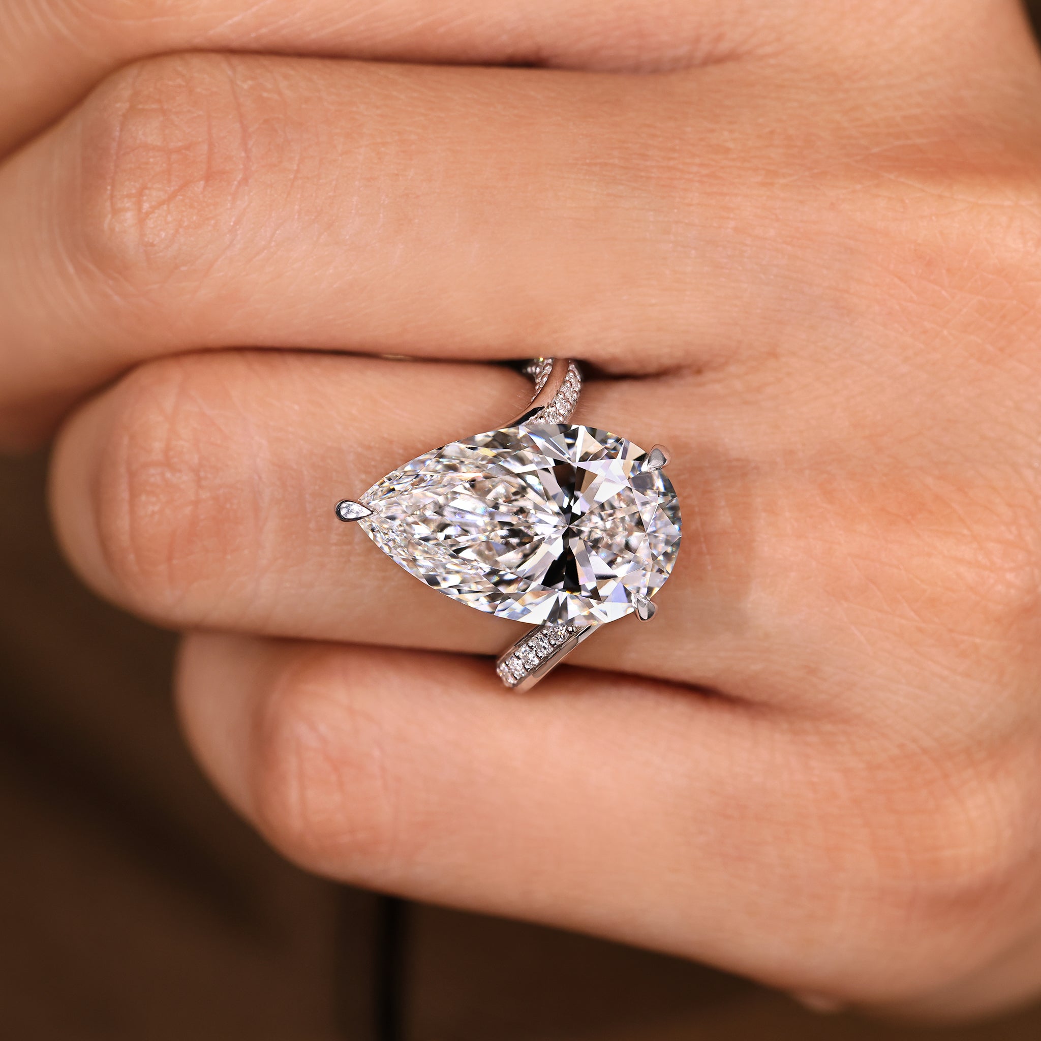 Pear shaped lab grown diamond ring with sparkling double row pave detailing.
