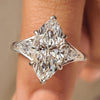Marquise diamond ring with pear side stone in three stone design
