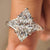 Marquise diamond ring with pear side stone in three stone design
