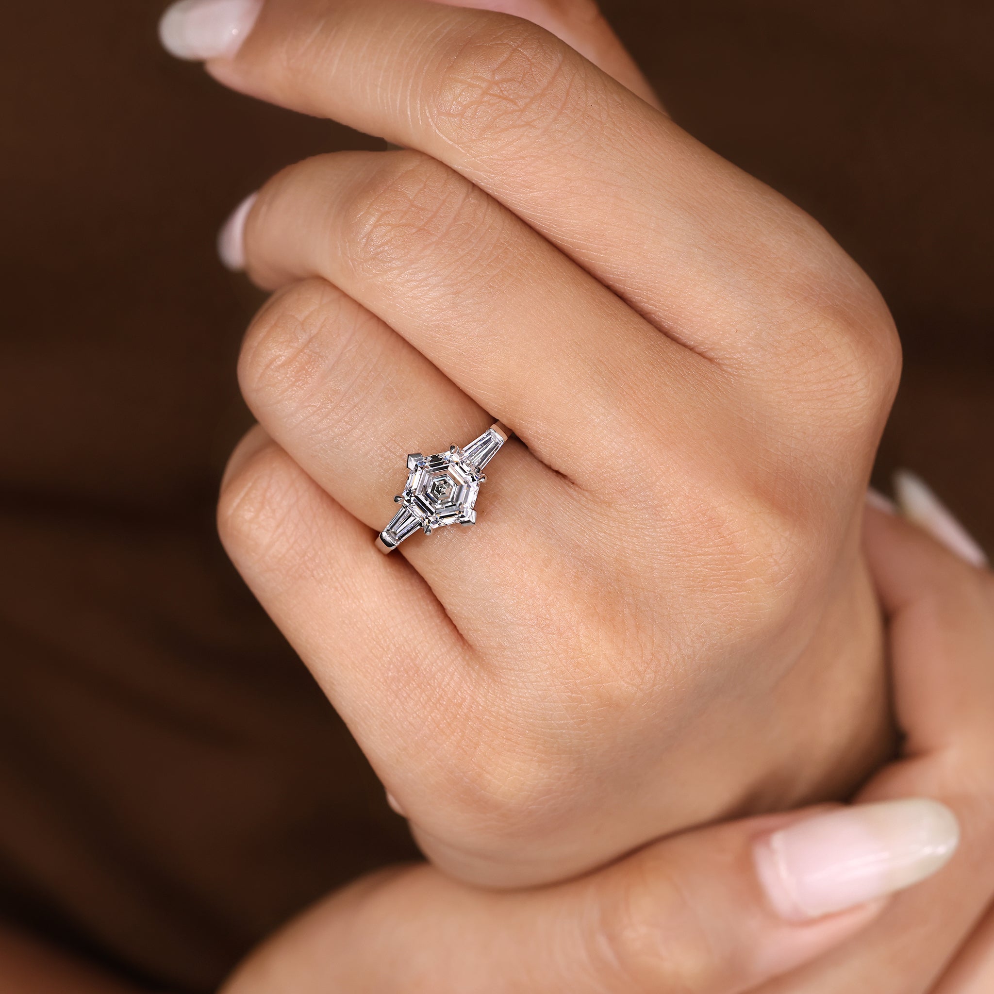 Hexagon center diamond ring with tapered baguette side stones.
