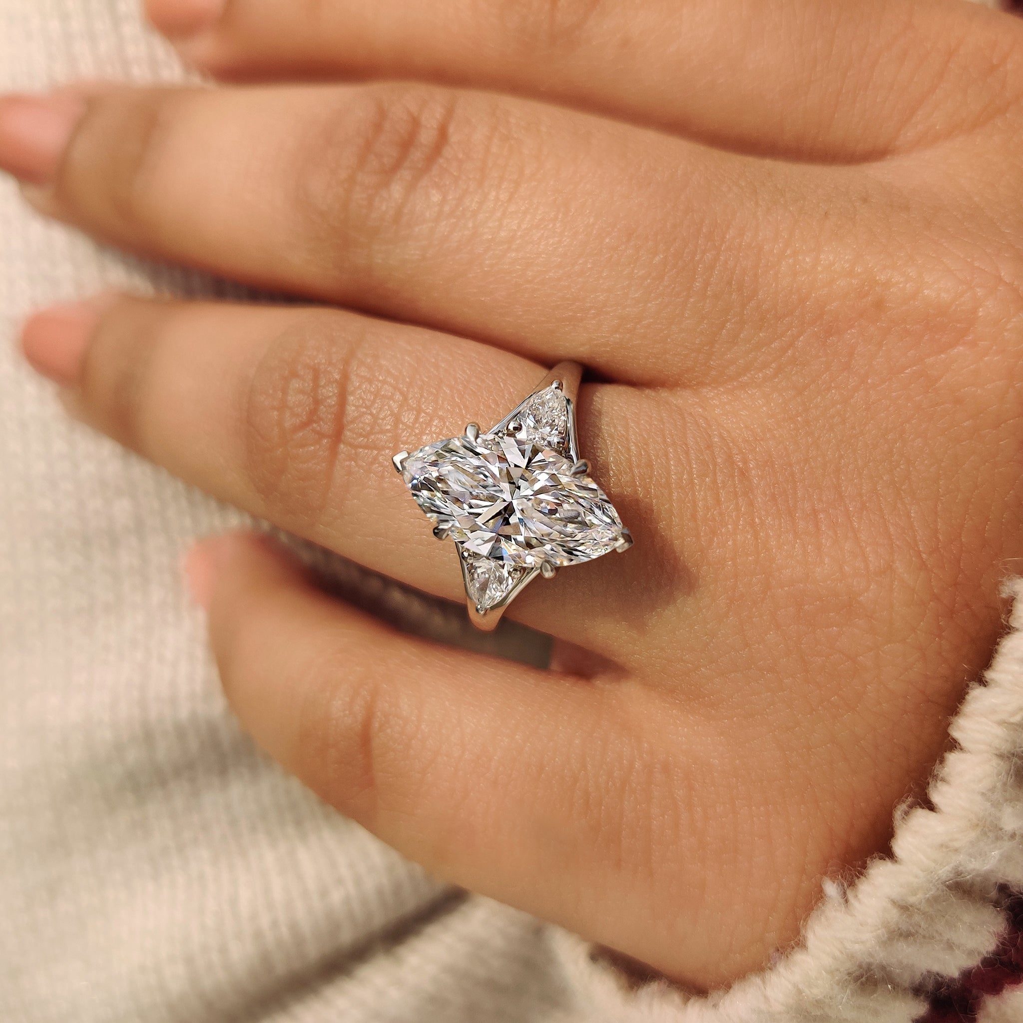 Marquise diamond ring designed with pear side stones
