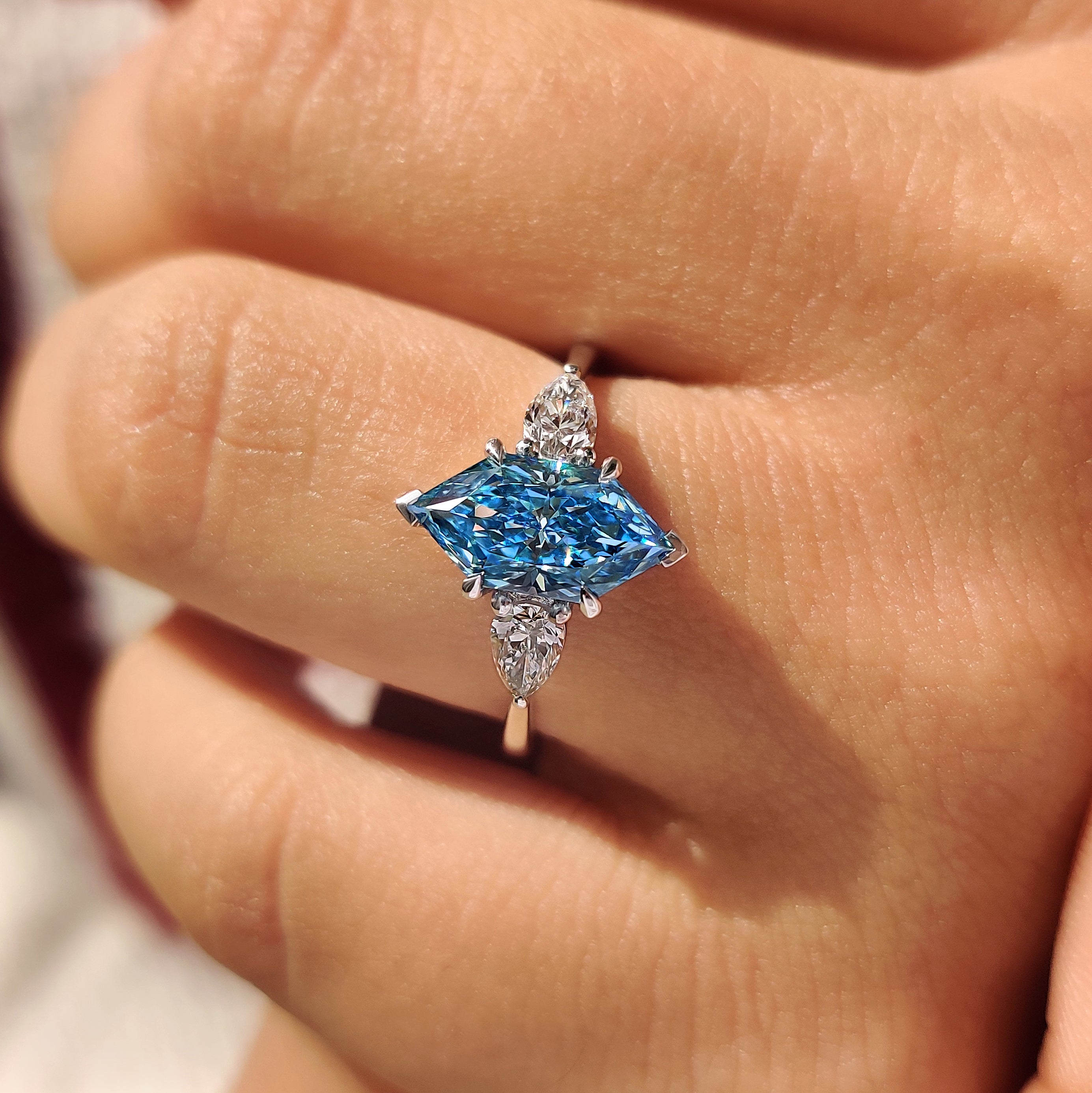 Blue dutch marquise diamond in basket setting with cathedral profile

