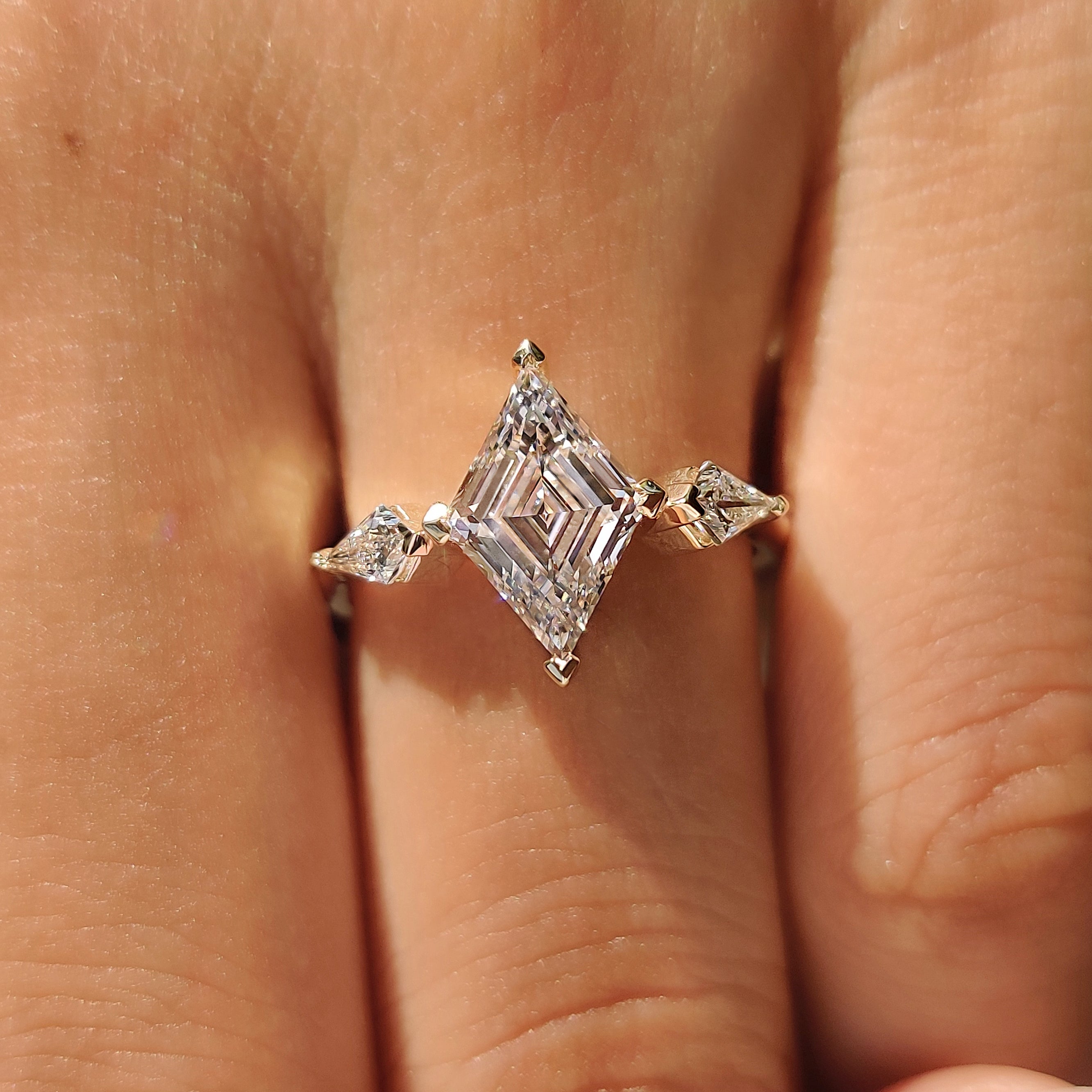 Lab grown diamond ring with lozenge center and side stones
