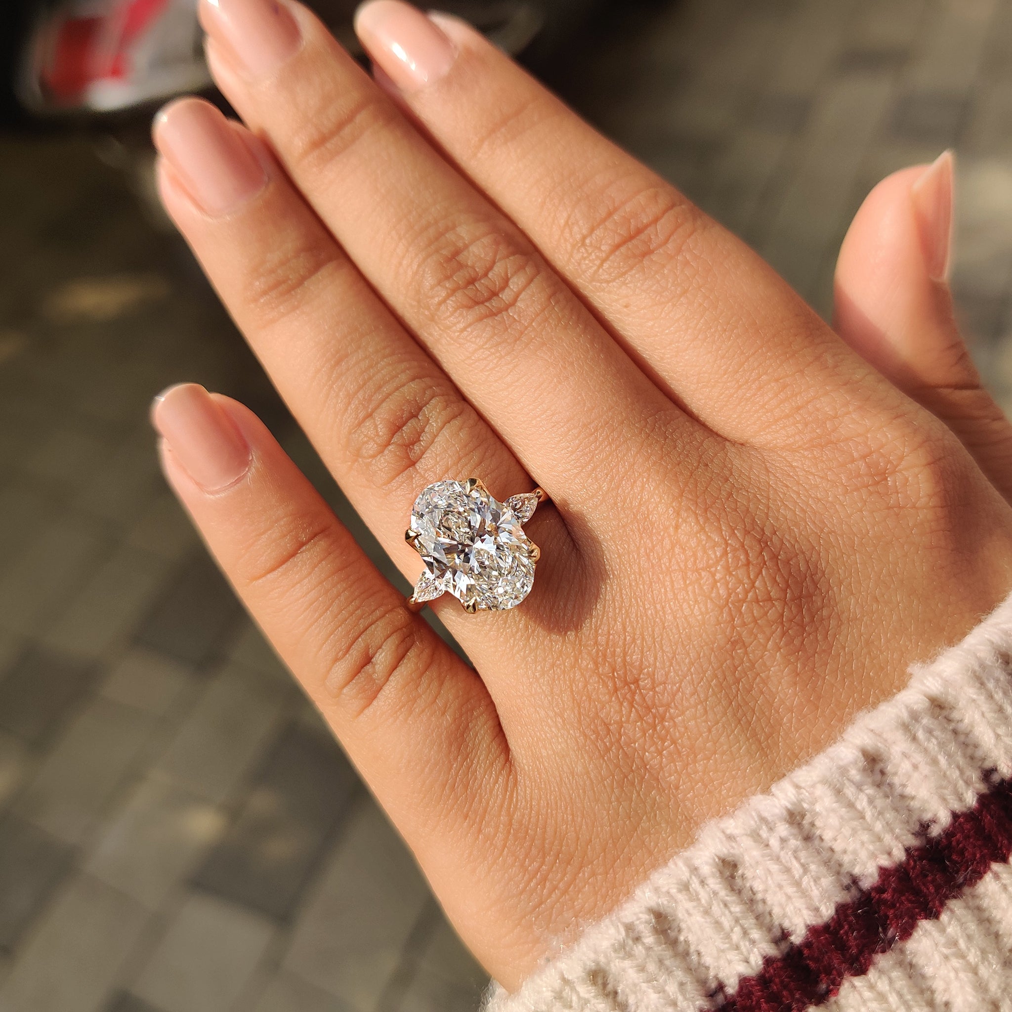 Handmade engagement ring with oval and pear shaped diamonds
