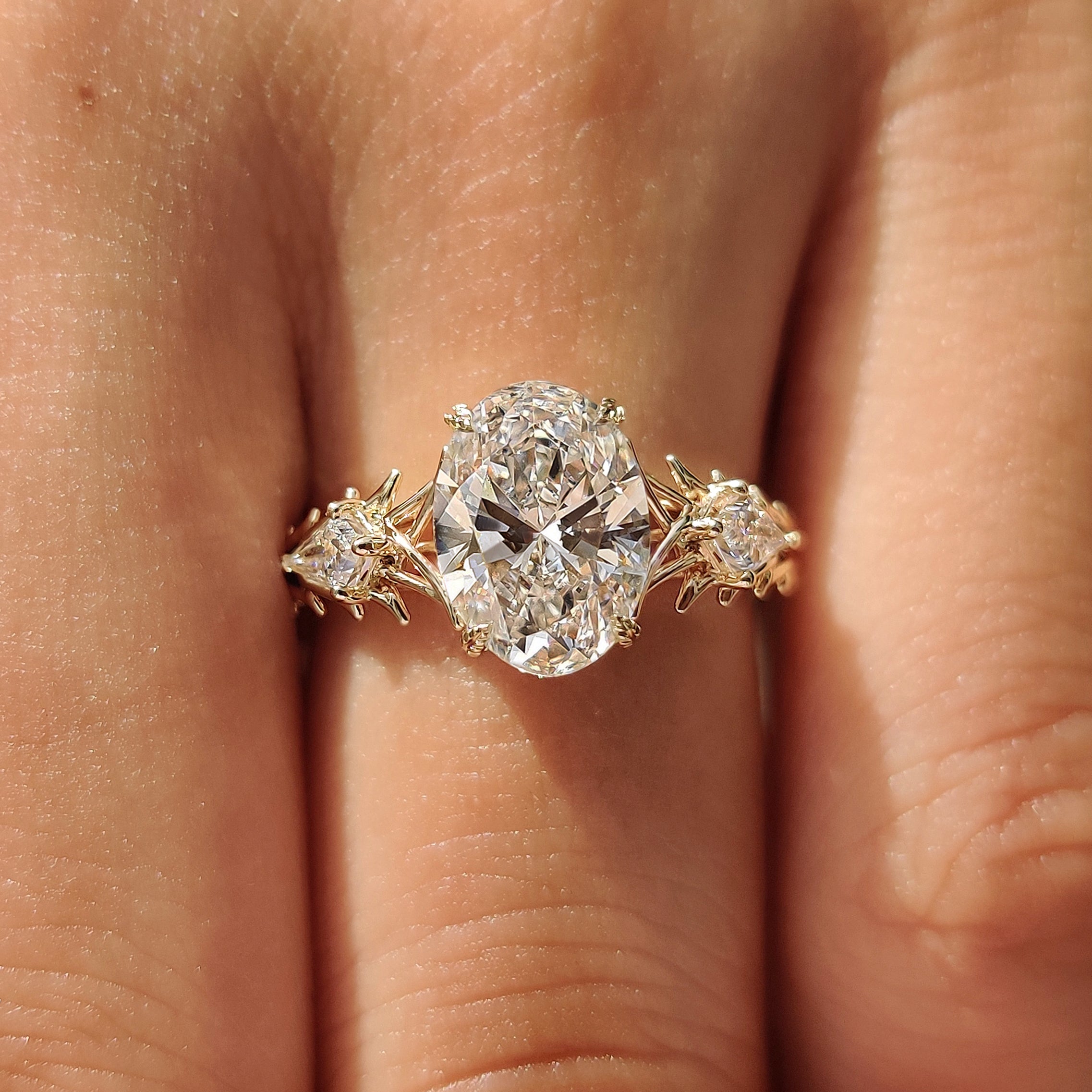 Three stone ring with round diamond accents
