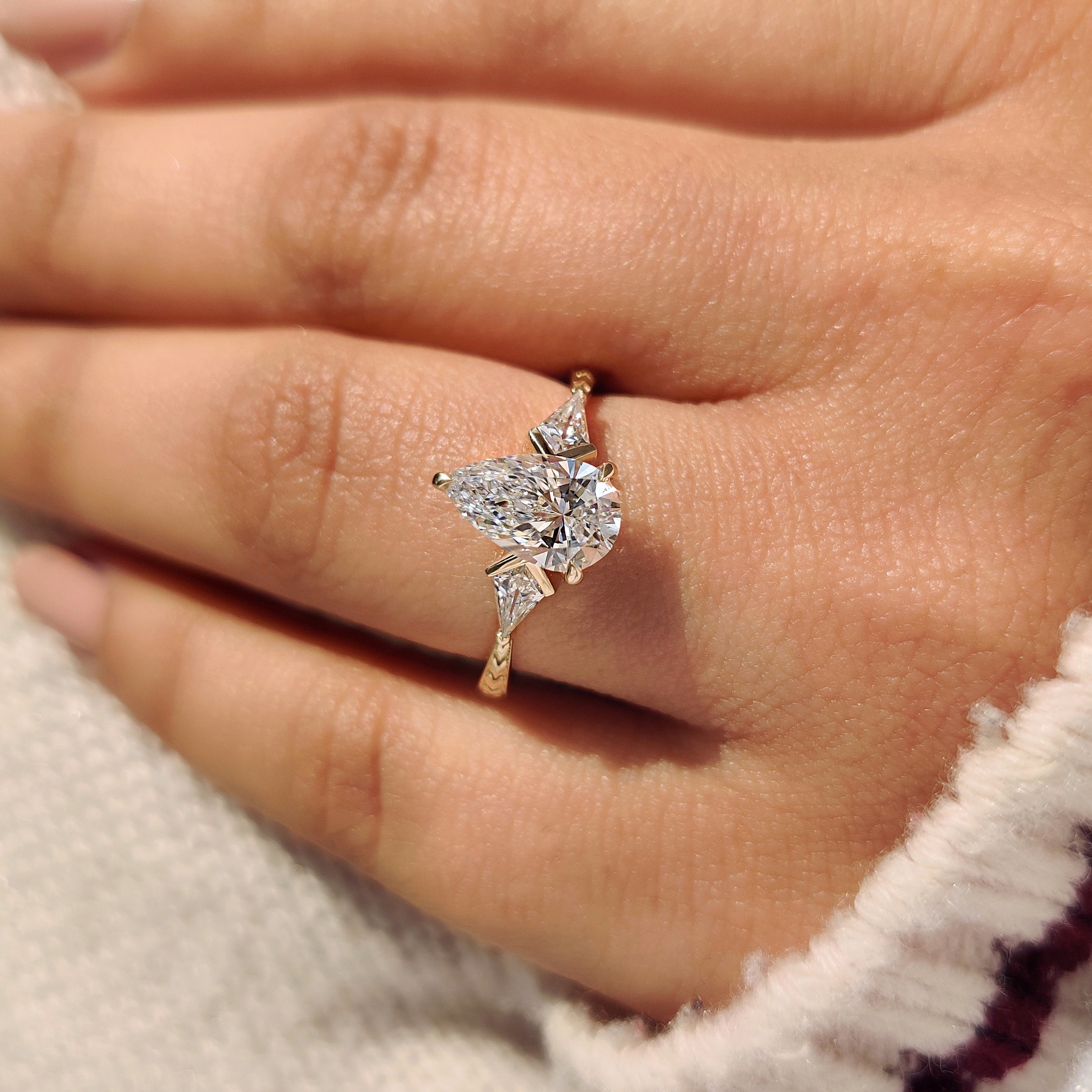 Art deco style three stone ring with tapered shank.
