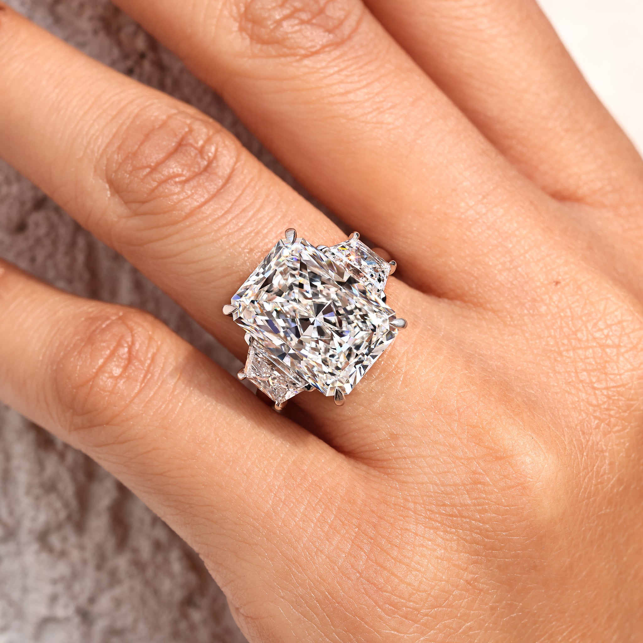 Lab grown radiant cut diamond ring with classic three stone setting.
