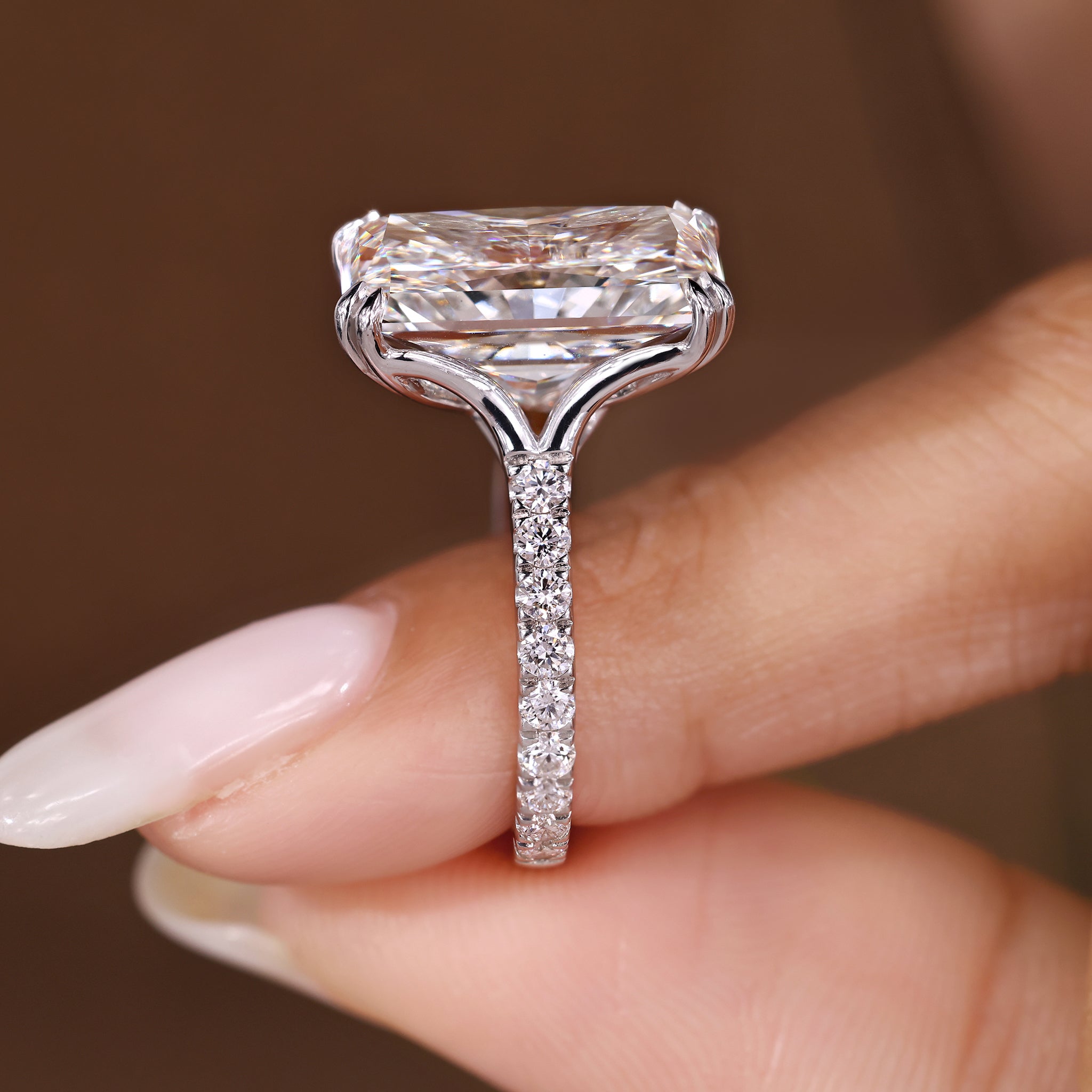 Radiant cut diamond ring with round diamond pave accents
