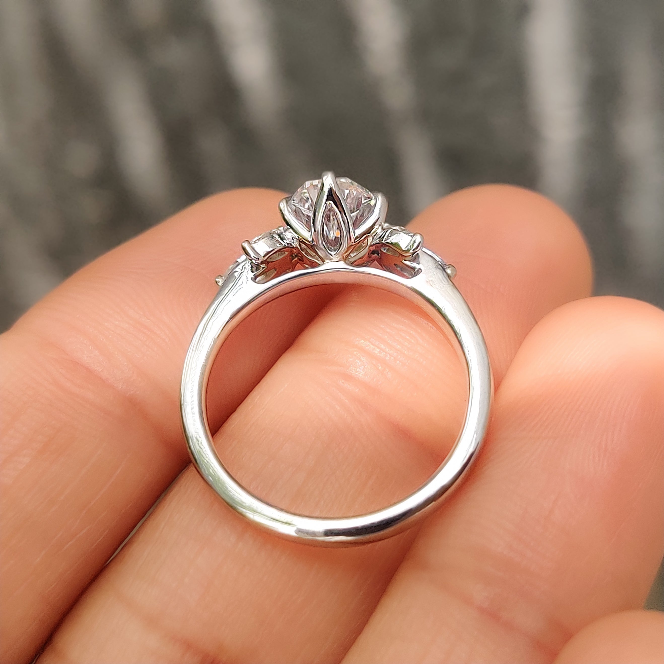 Handmade oval diamond ring with marquise side stone accents

