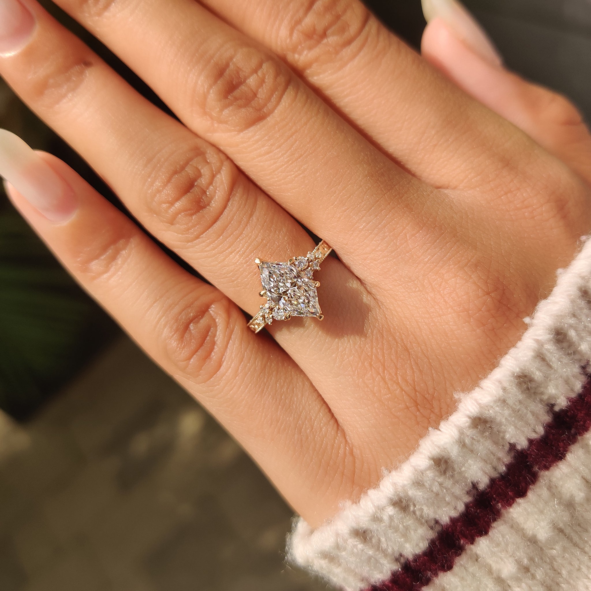Lab grown marquise diamond ring with floral accents.

