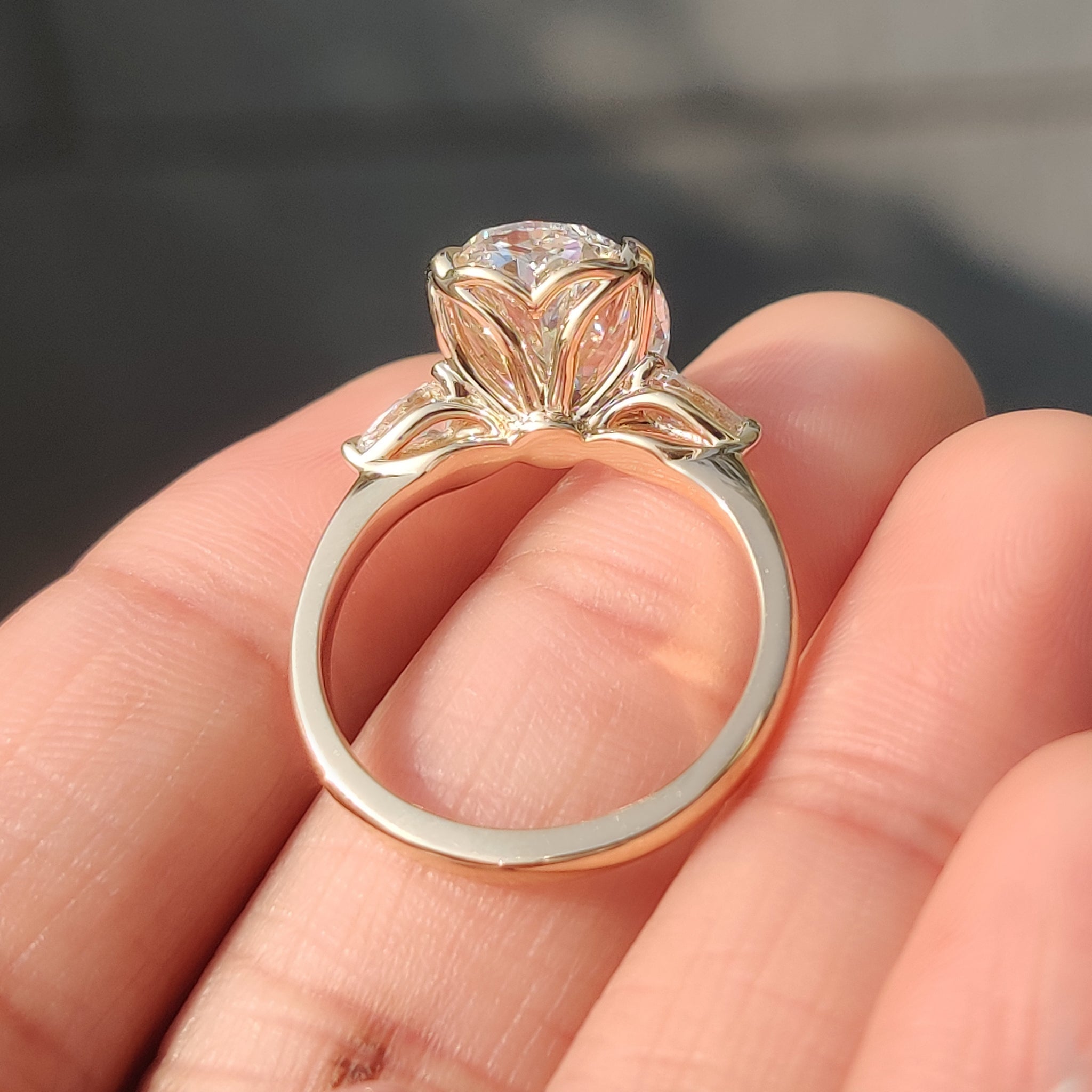 Oval lab diamond ring with pear side stone accents
