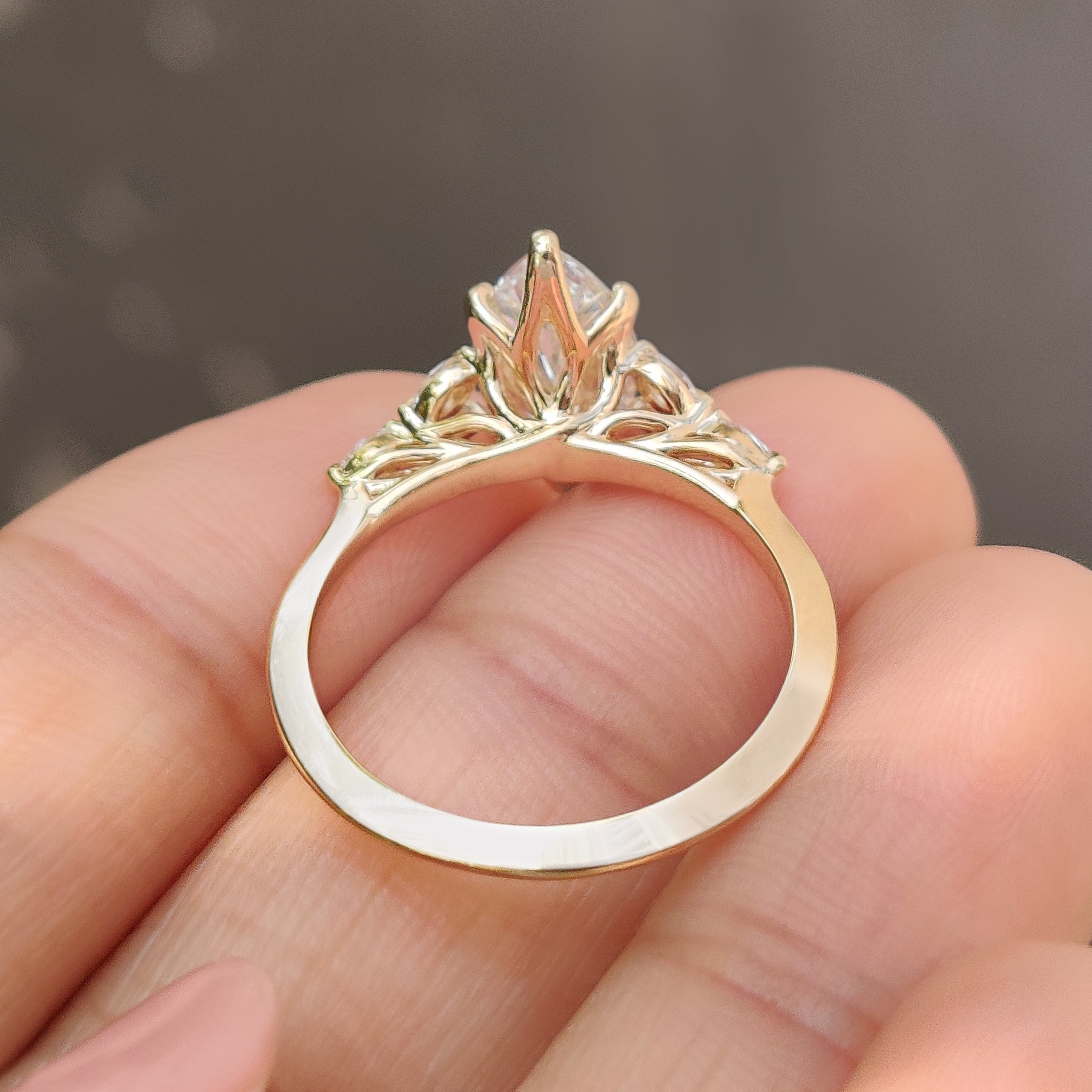 Marquise diamond ring with muse setting and side stones
