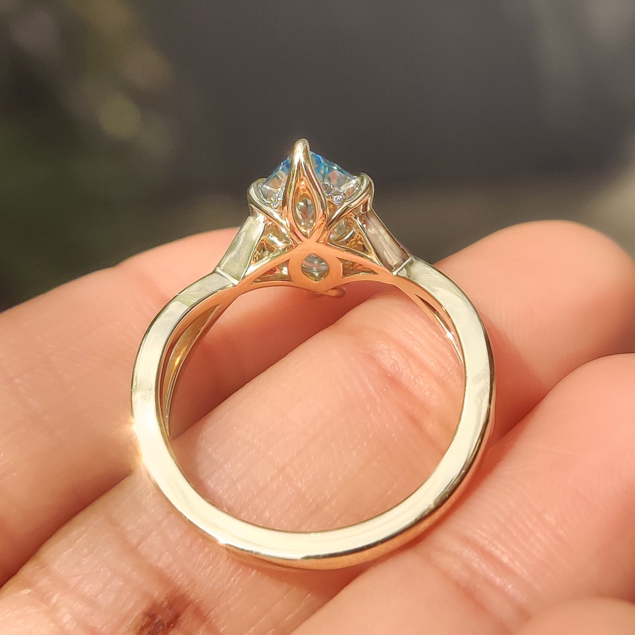 Twisted shank aquamarine ring with tulip style setting details

