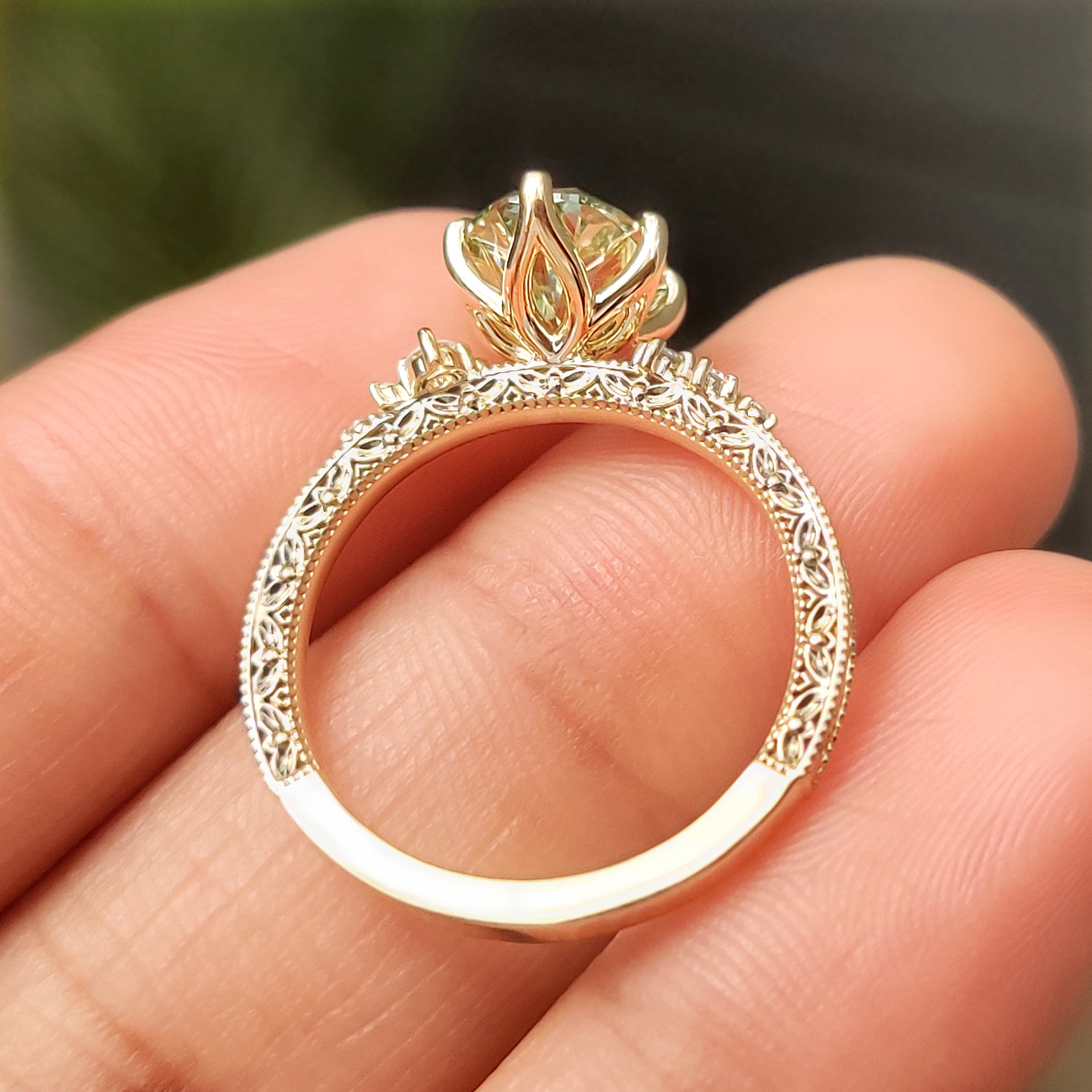 Round side stones with green oval center diamond
