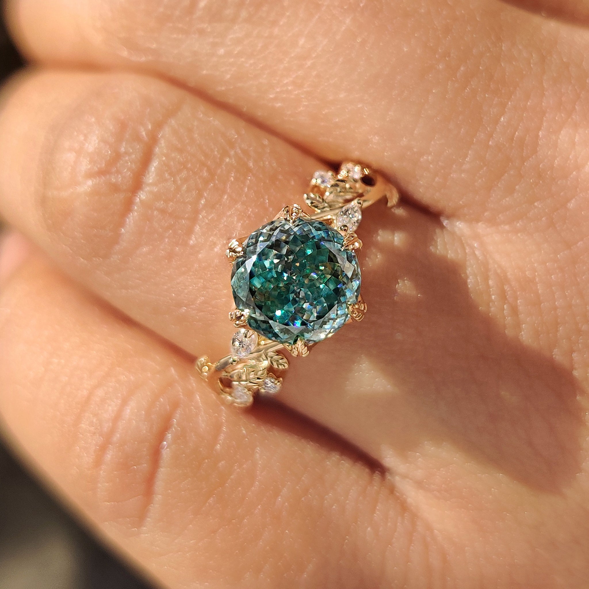 Nature inspired cyan moissanite ring with marquise round accents.
