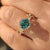 Nature inspired cyan moissanite ring with marquise round accents.
