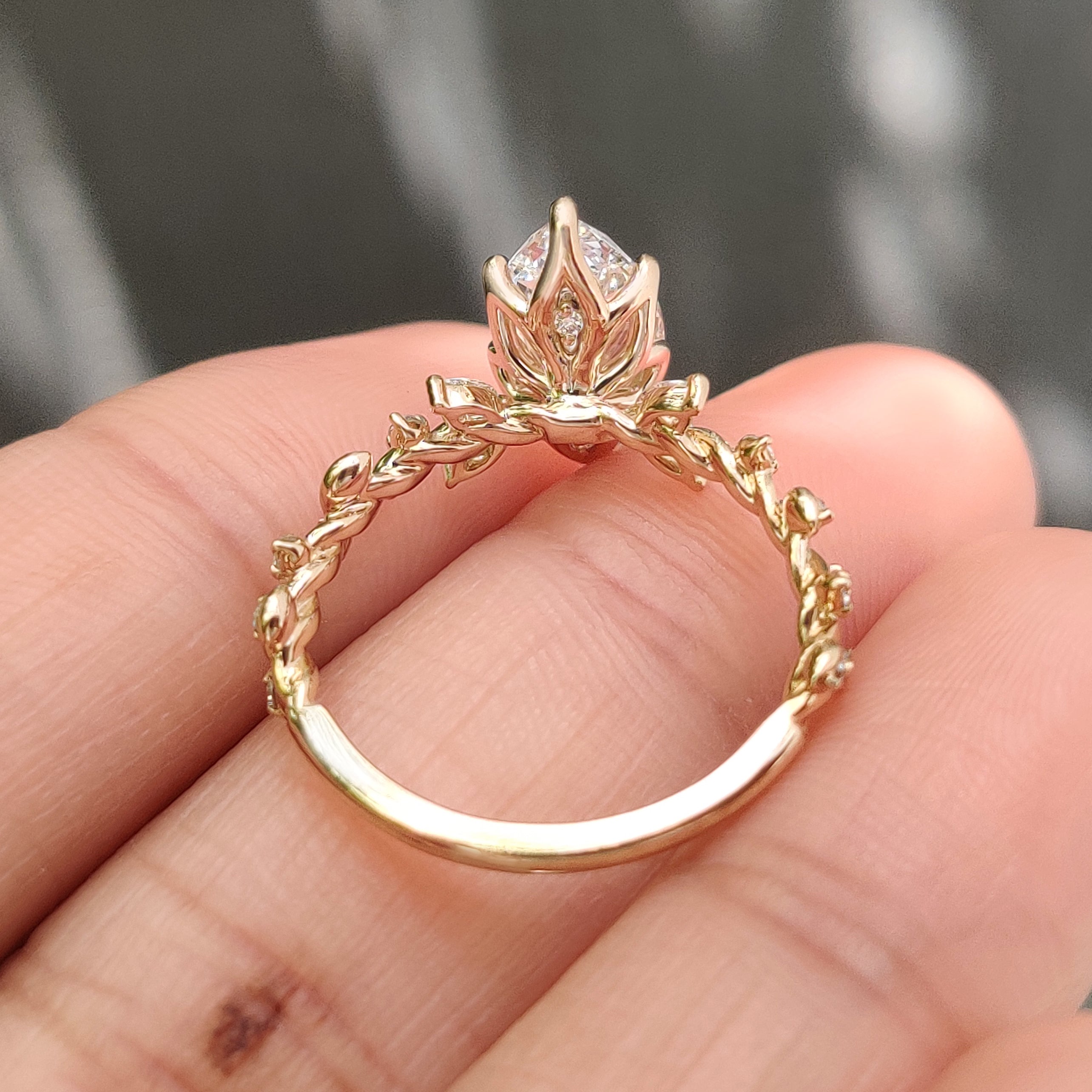Tulip setting marquise diamond ring with handcrafted details.
