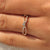 Half eternity wedding band with twisted band design.
