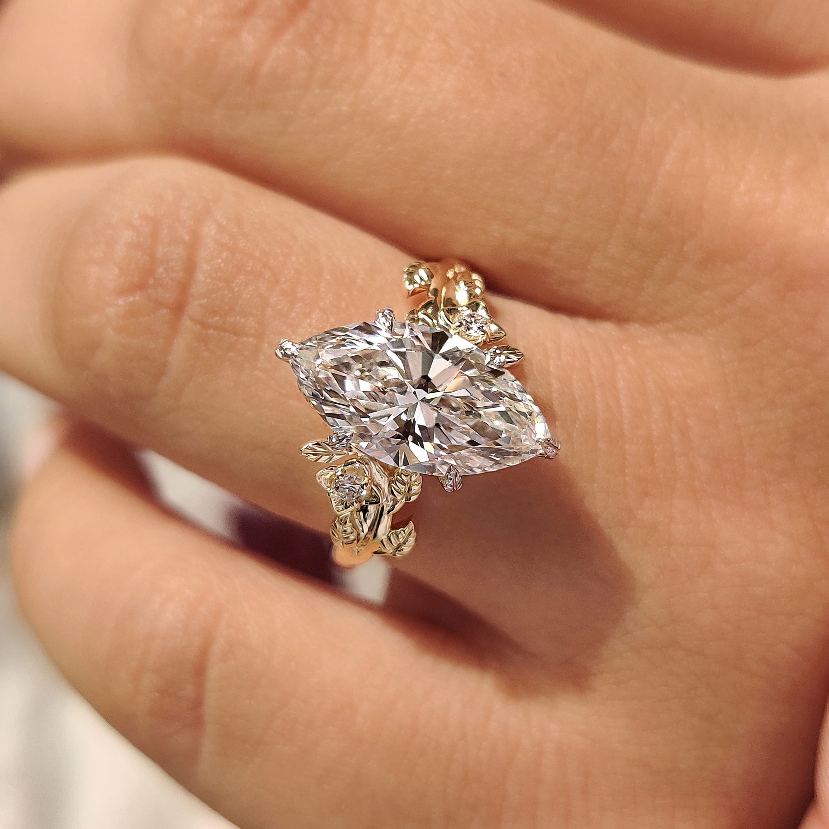 Marquise center diamond set with six claw prongs
